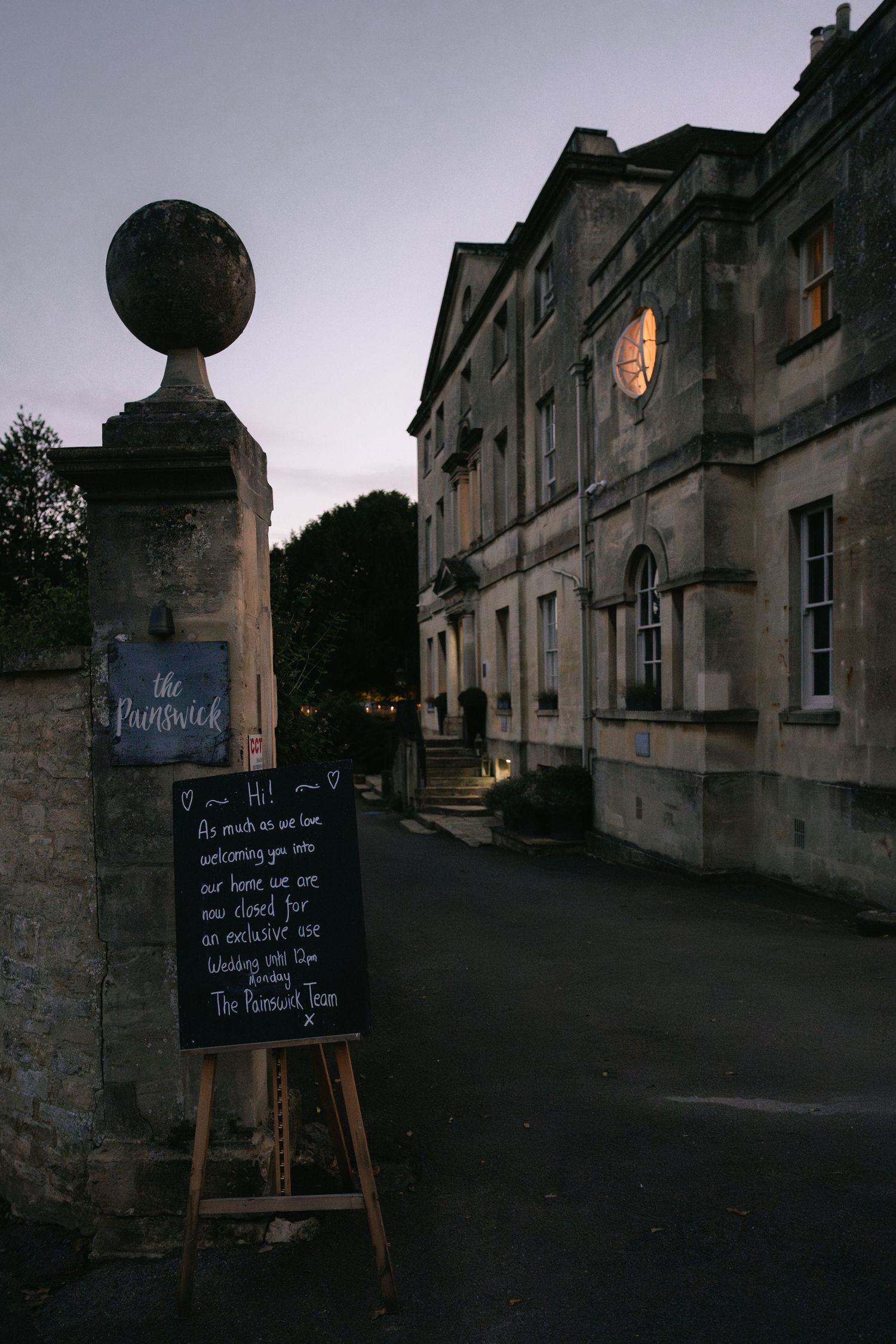 A series of moody evening street scenes in a historic town with chalkboard signs and stone buildings at dusk.