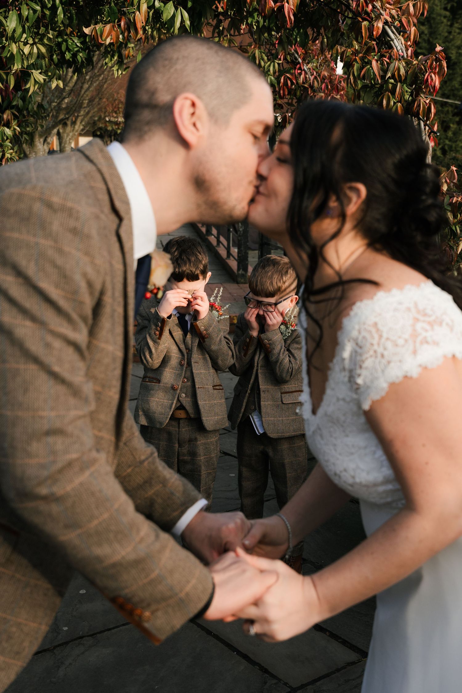 A romantic sequence of wedding photos shows a couple sharing a tender kiss under autumn foliage.