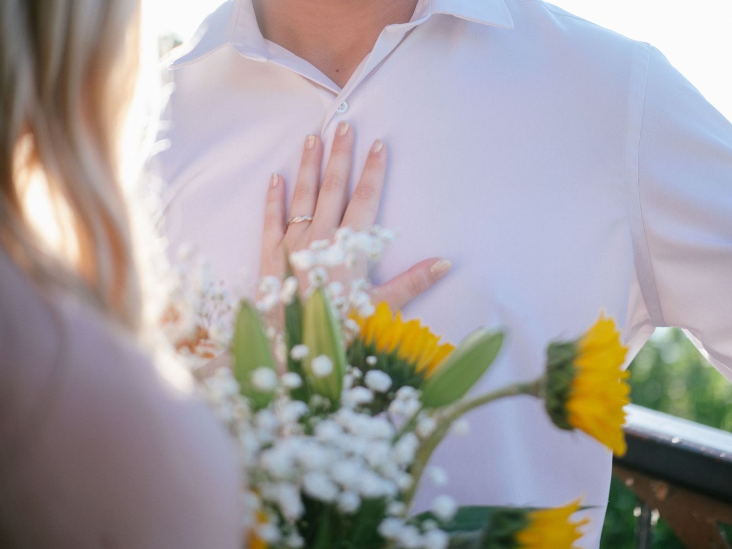 Wedding party bouquets featuring bright yellow sunflowers and white flowers create a cheerful summer celebration.