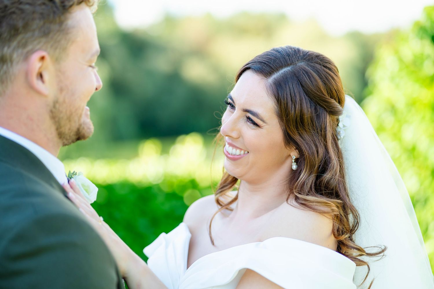 Happy couple shares intimate moments during their outdoor wedding celebration.