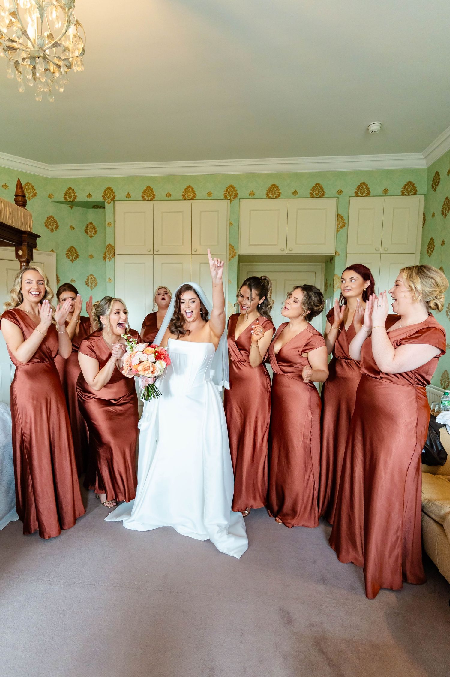 A sequence of wedding party photos showing bridesmaids in rust-colored dresses posing playfully with the bride in white.