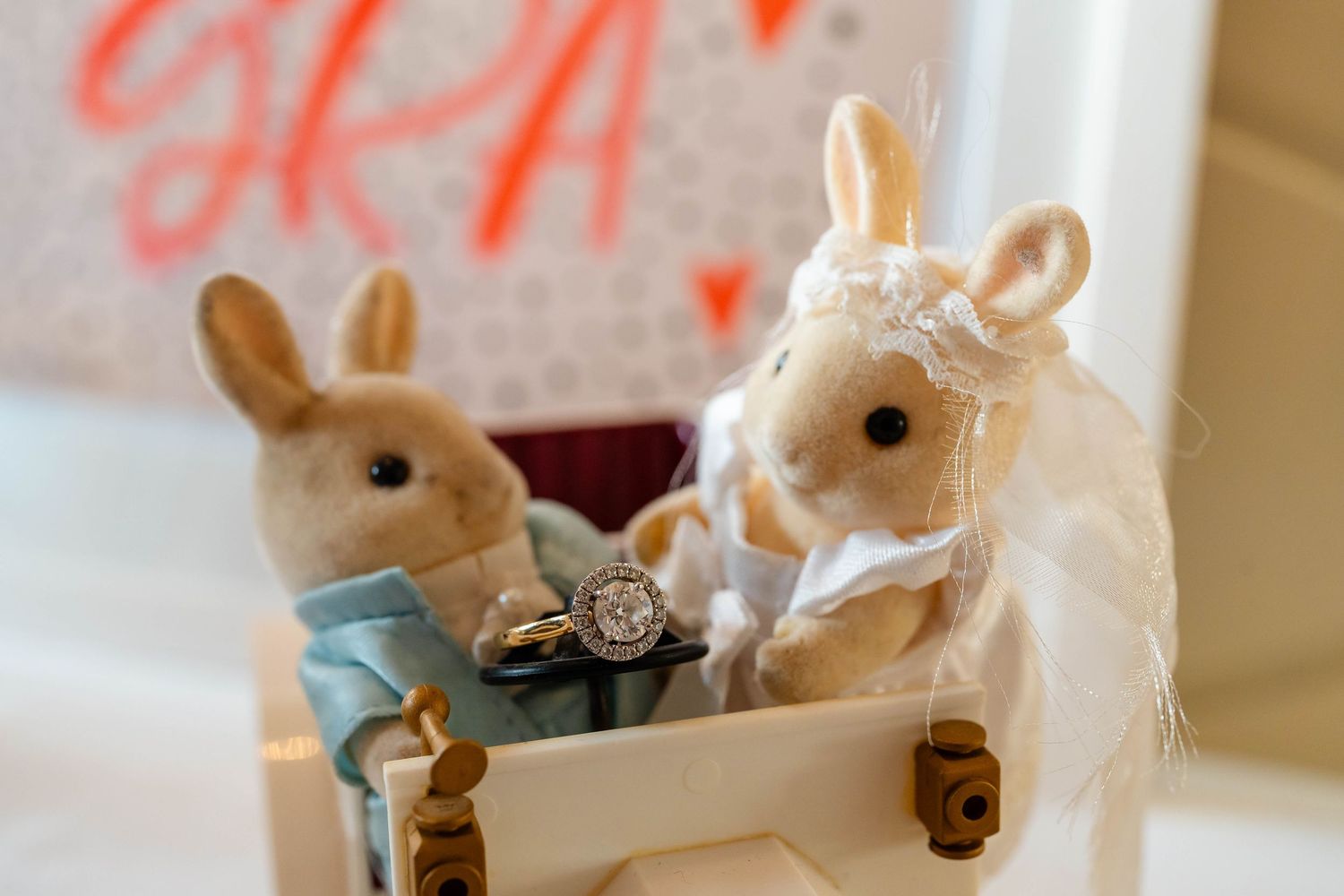 Decorative ceramic bunnies dressed as bride and groom for wedding cake topper.