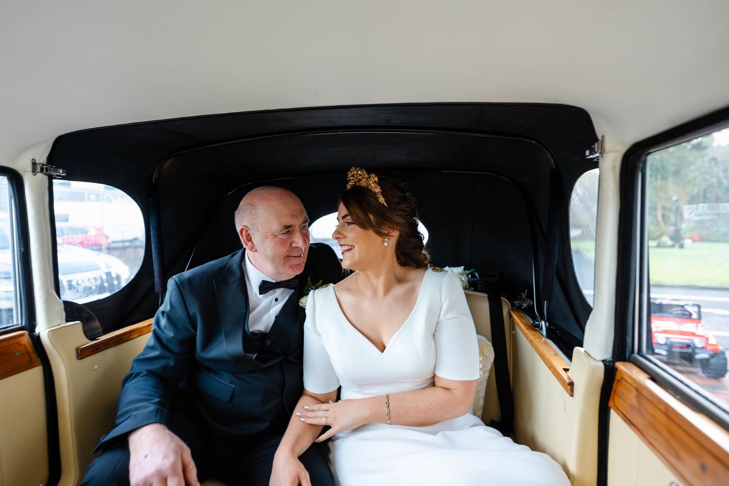 Wedding party traveling in a classic vintage car.