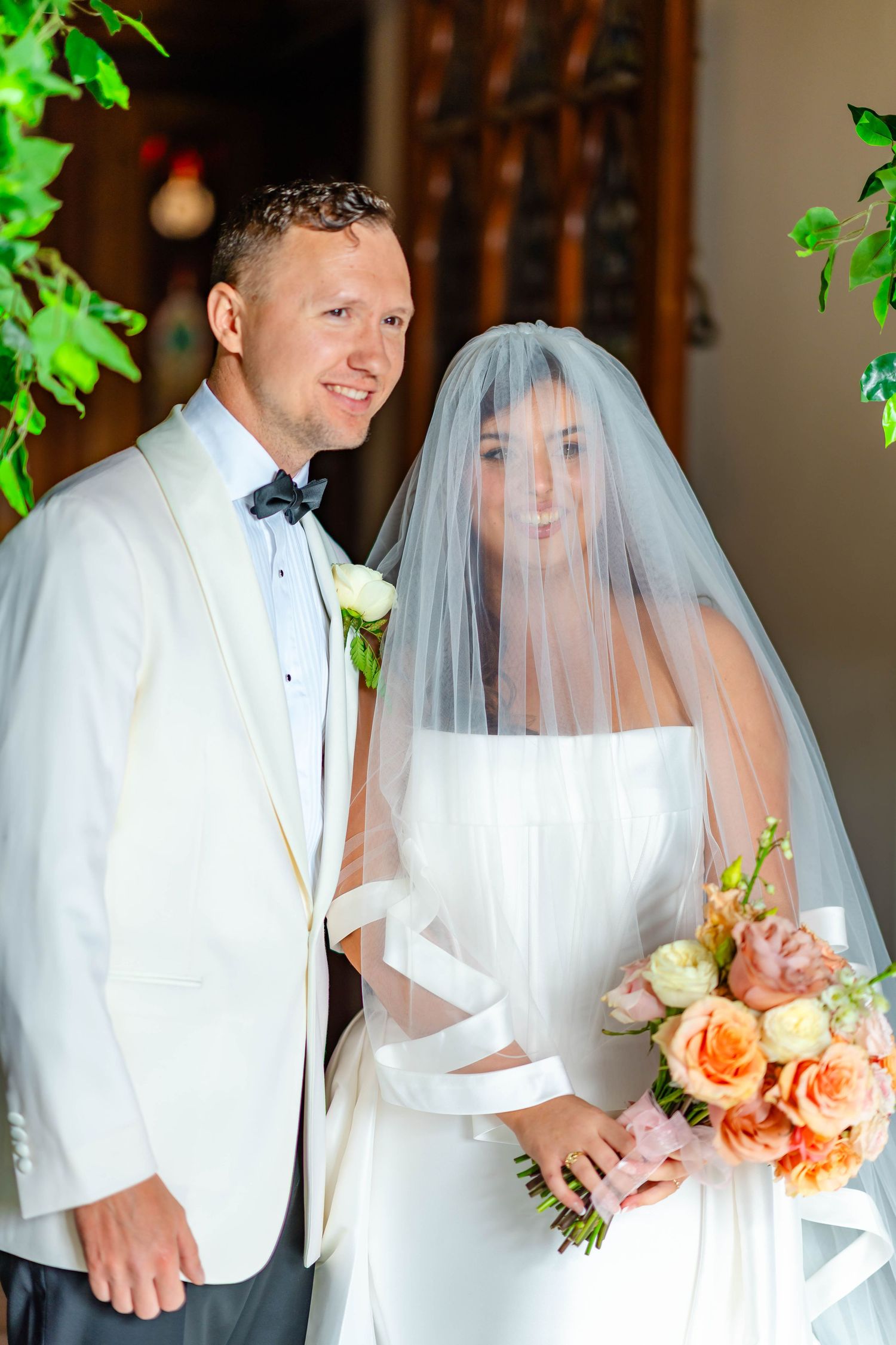 A series of wedding photos showing a couple in white attire with peach-colored floral bouquet and flowing veil.