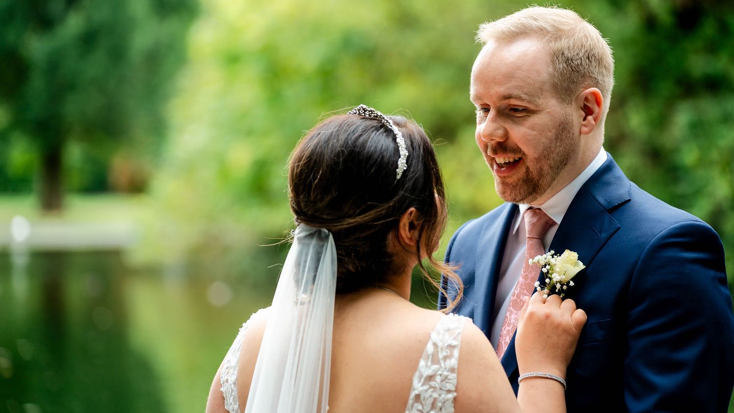 A romantic wedding couple shares intimate moments in a lush garden setting with soft natural lighting.
