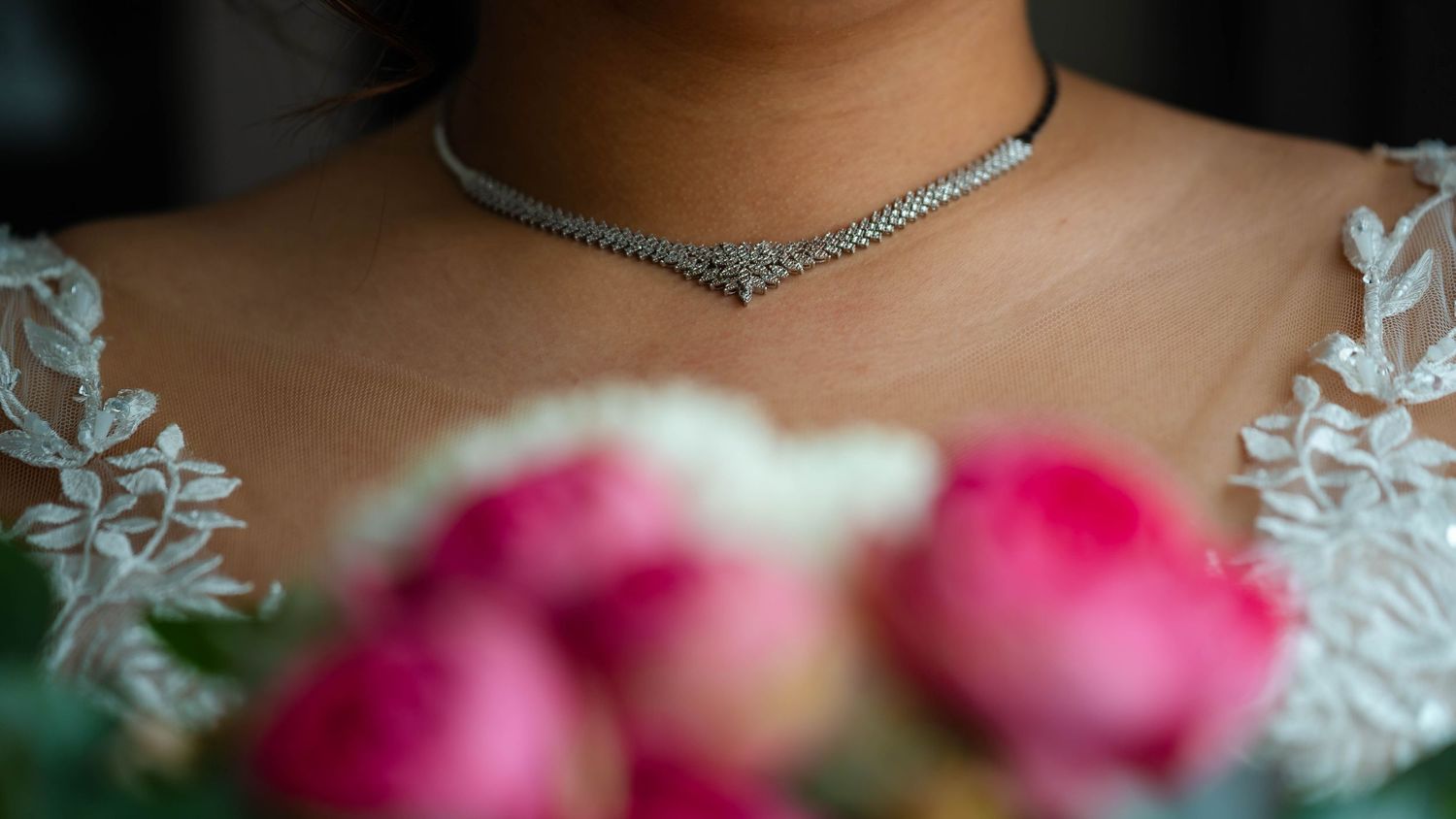 Close-up detail of wedding jewelry and accessories with soft lighting.