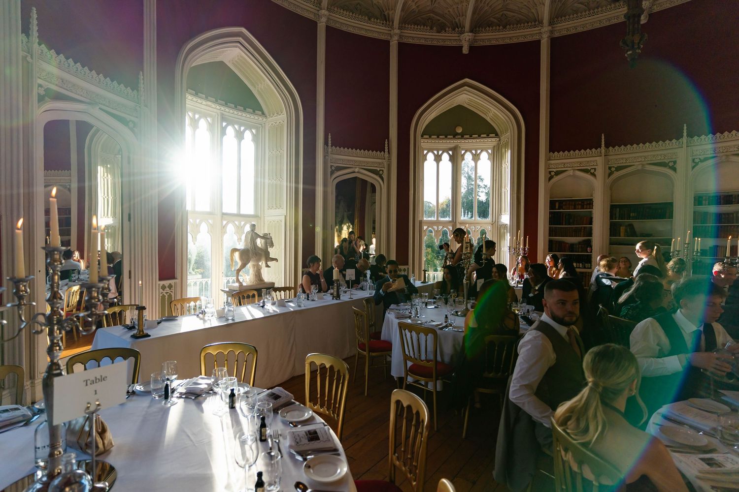 Elegant wedding ceremony setup in a historic church with sunlight streaming through stained glass windows.