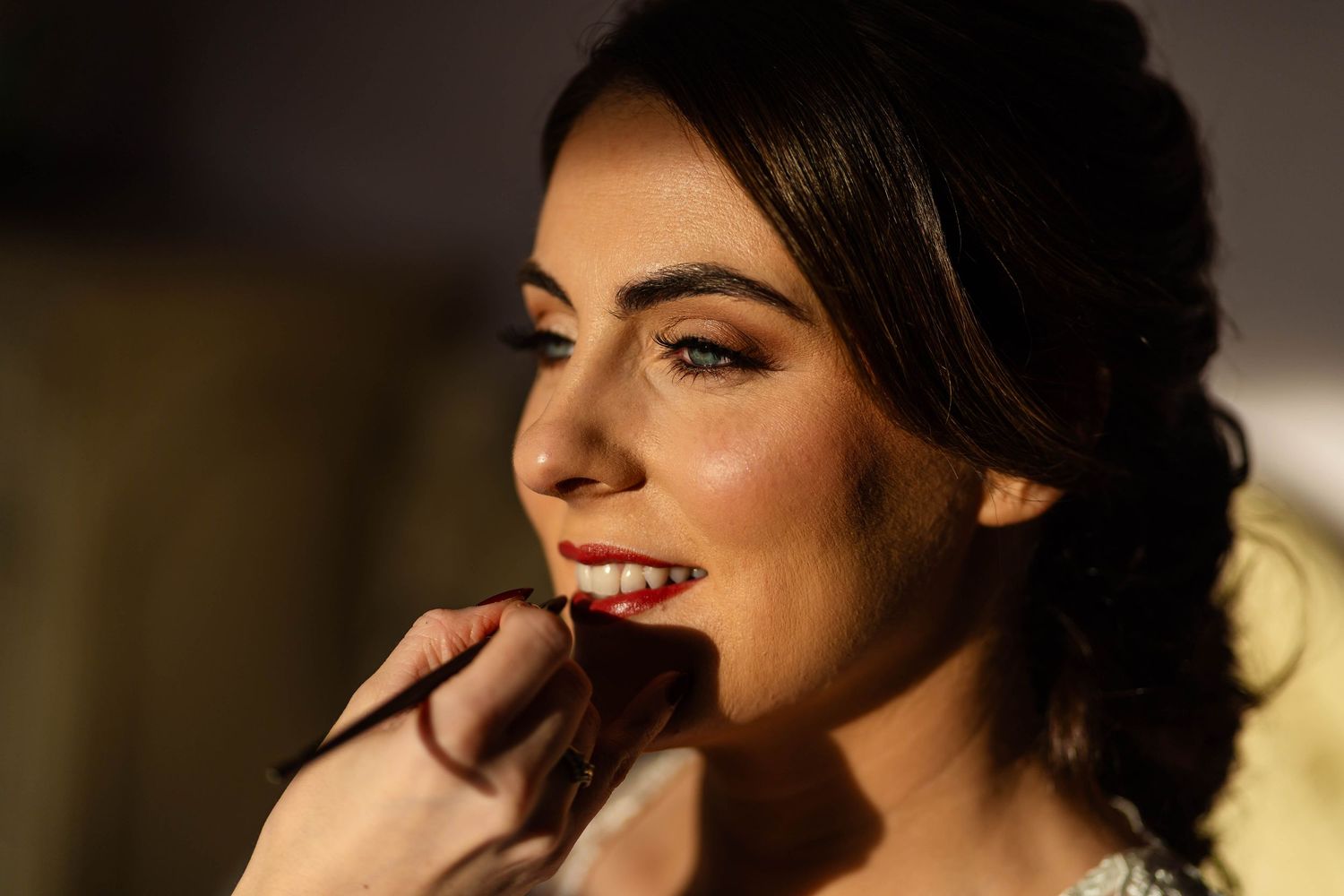 Close up beauty portrait showing elegant bridal makeup and hairstyling details.
