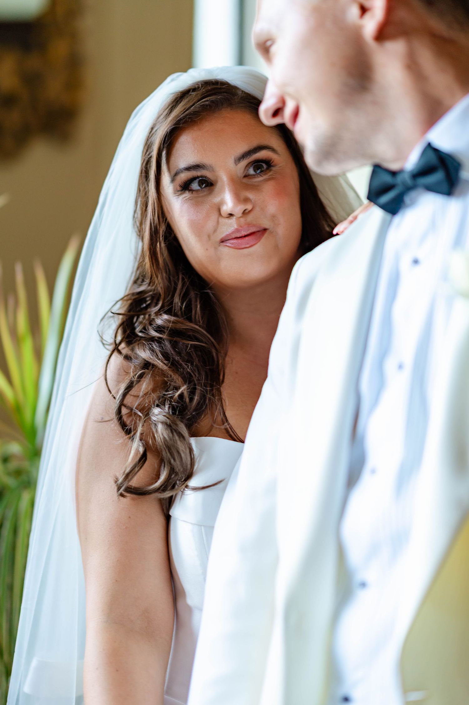 A bride and groom share intimate moments in a series of romantic wedding portraits with soft natural lighting.