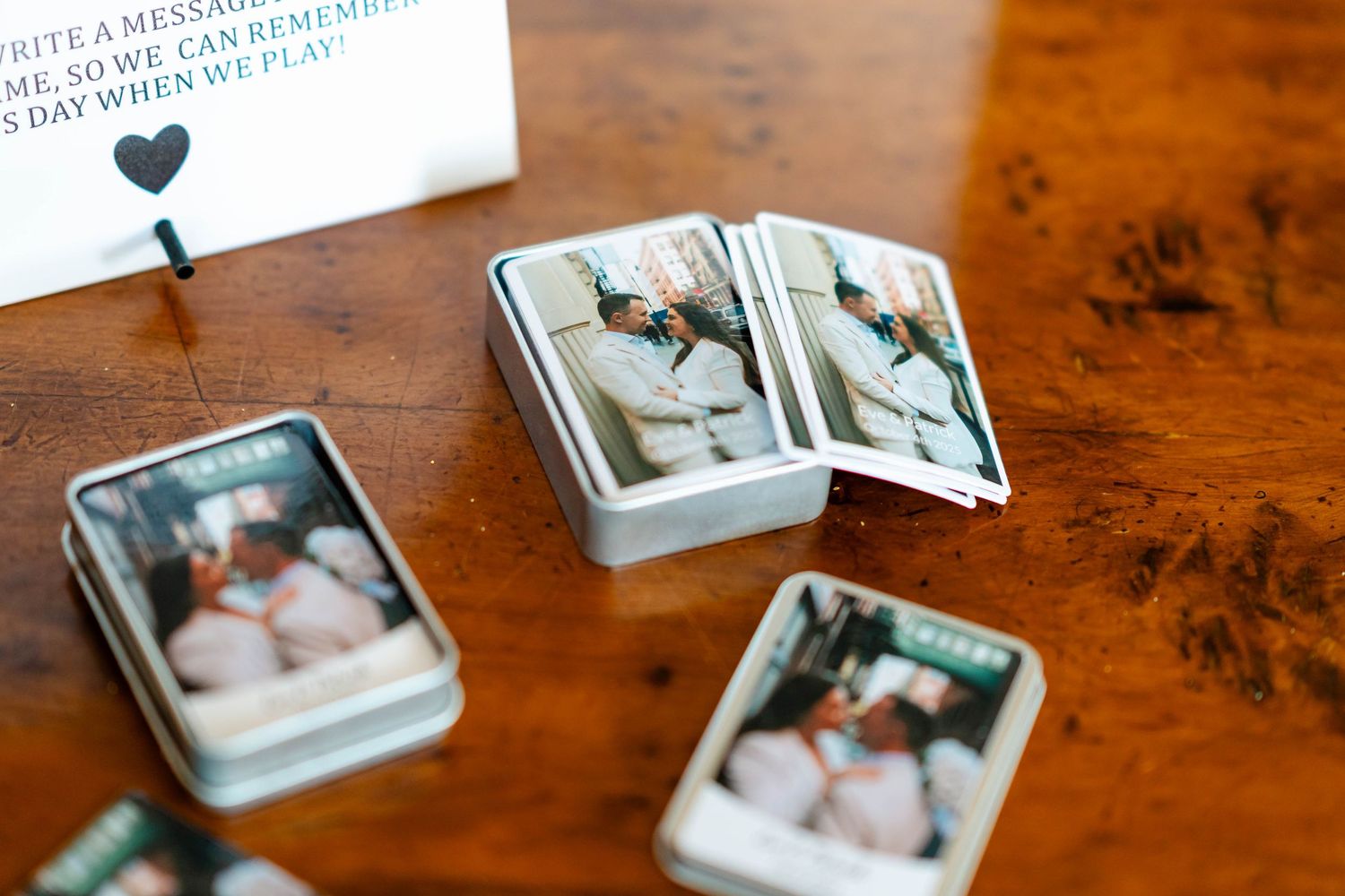 Small photo prints arranged on a wooden table surface with vintage-style polaroid-like frames.