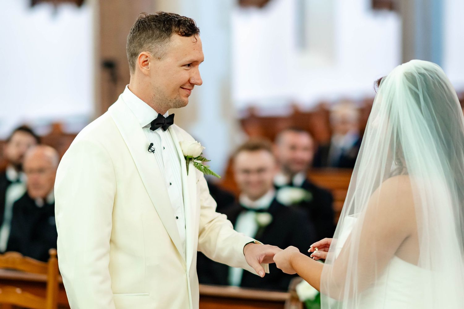 A bride and groom exchange vows during a traditional church wedding ceremony.