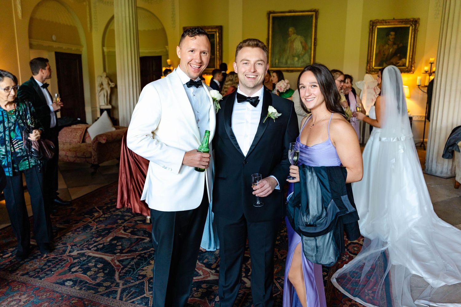 Wedding reception guests dancing and celebrating on the dance floor at an elegant indoor venue.