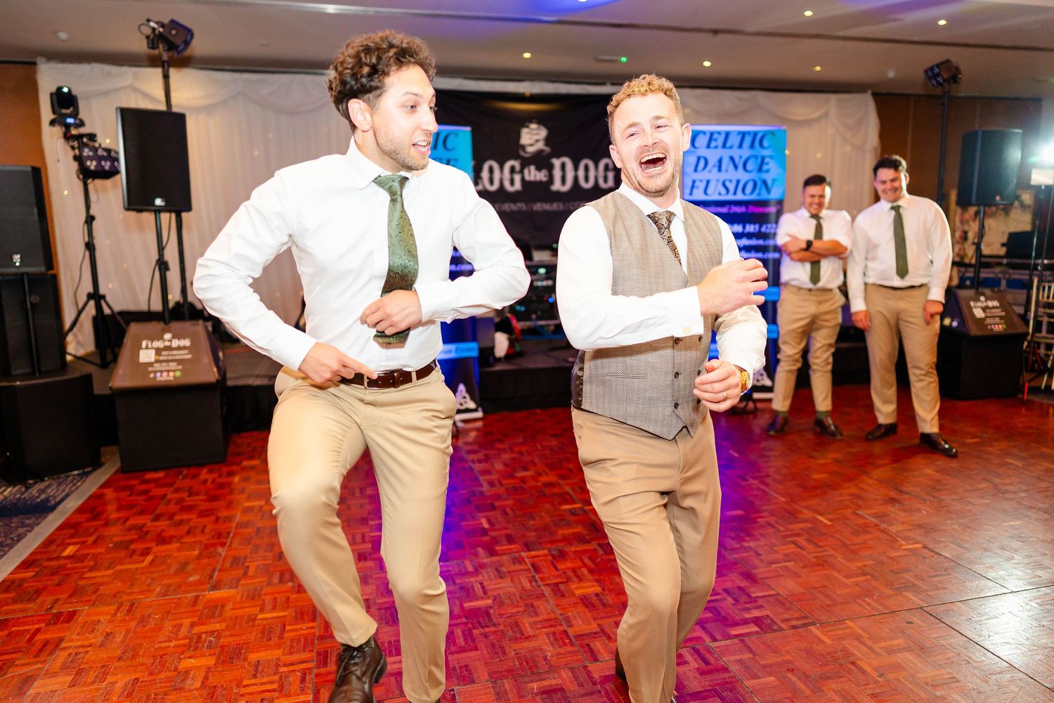 Wedding reception dance party with guests enjoying lively celebration on red dance floor.