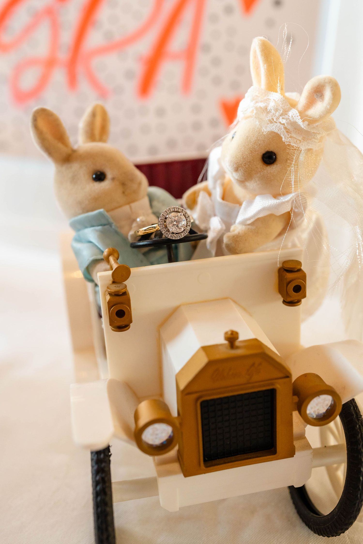 Decorative white plush bunnies arranged on display stands with rustic wooden accents.