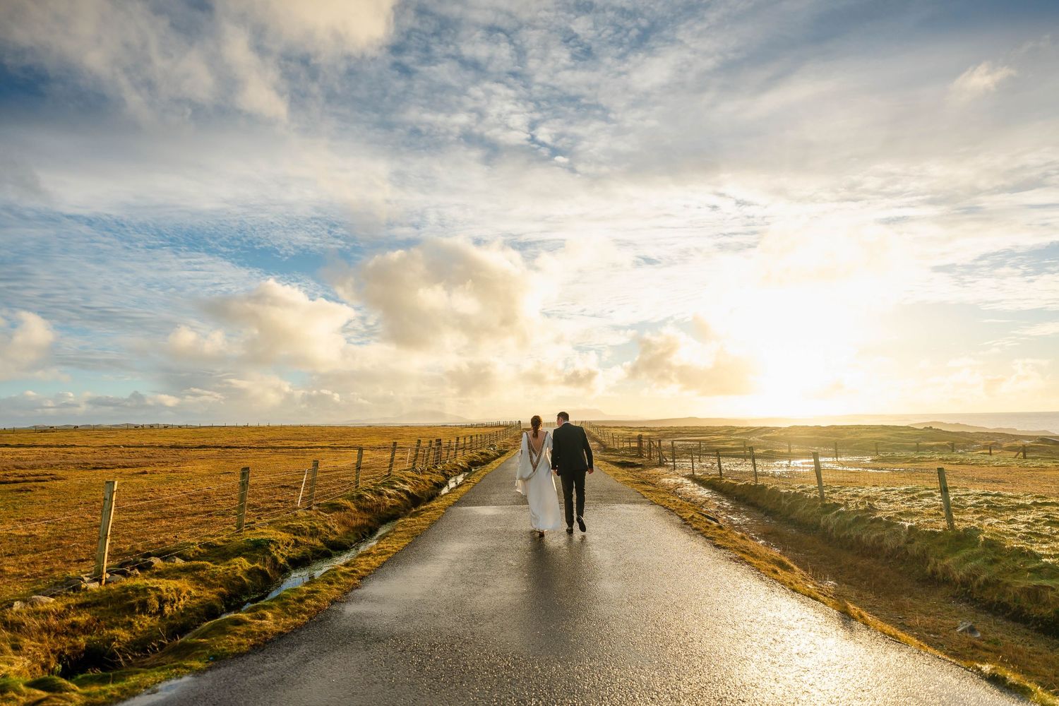 Atmospheric panoramic view of a rural road stretching into the distance under moody skies.