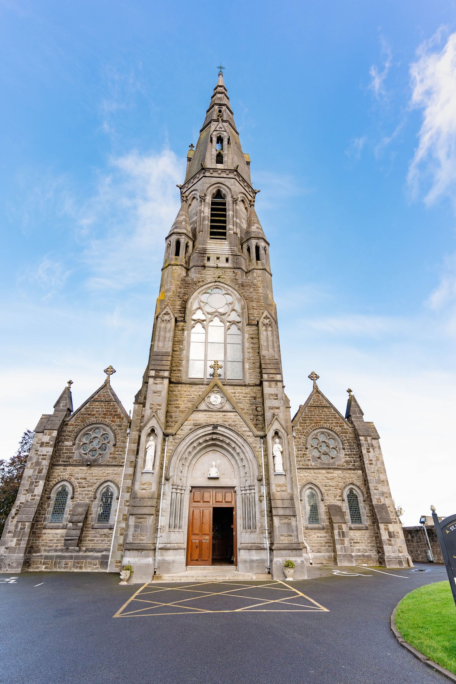 A sequence of five exterior views of a Gothic stone church with spires and arched entrances under blue skies.
