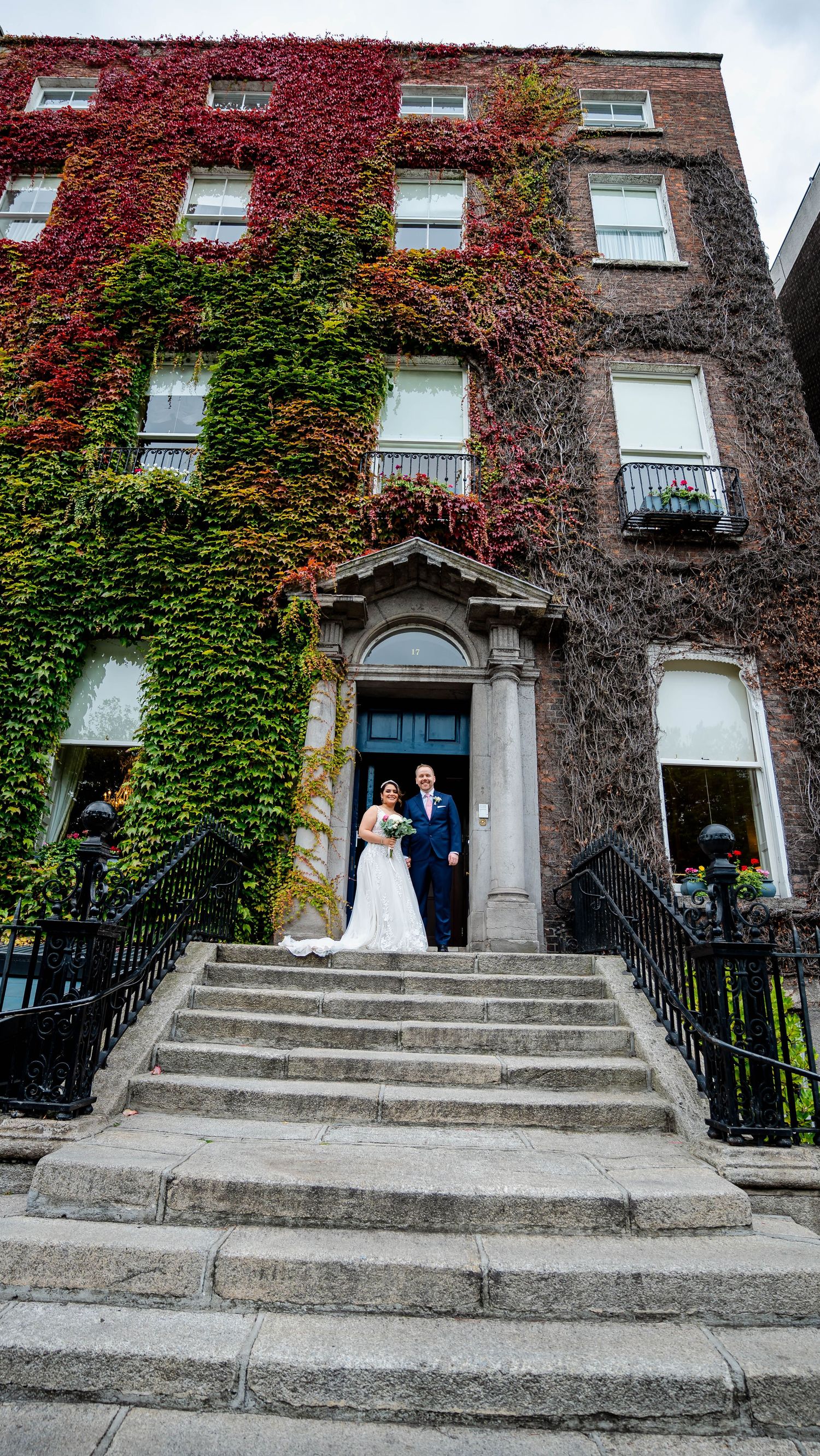 Historic ivy-covered building with stone steps and ornate entrance.