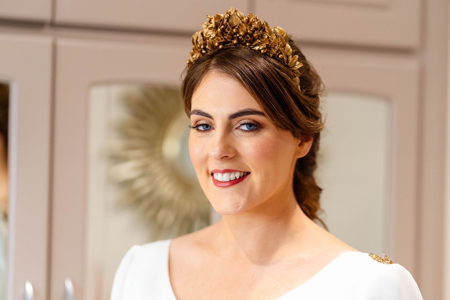 Bridal portrait showing elegant hair styling with gold crown accessory.