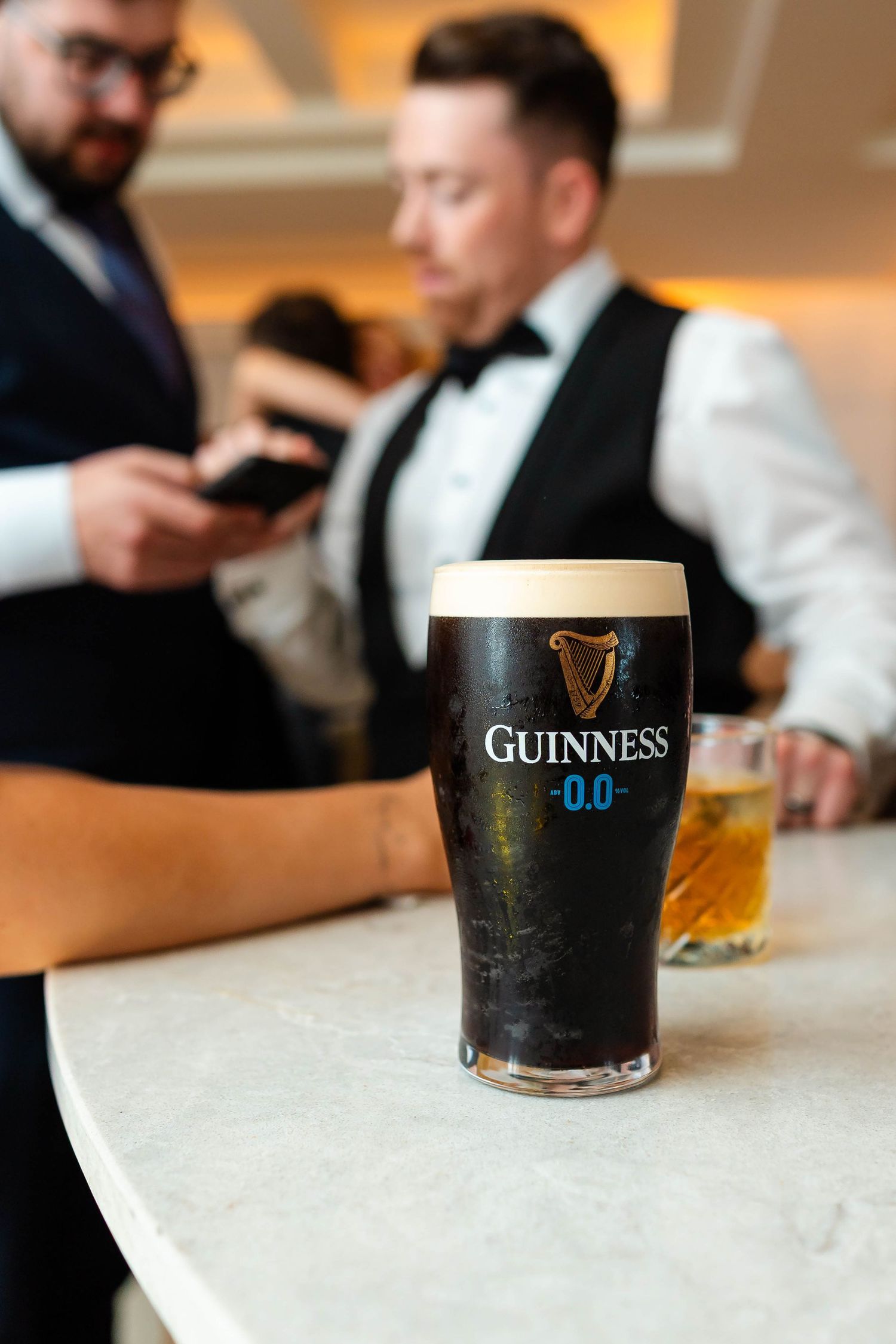 Several pints of Guinness beer arranged on a counter during a celebration.