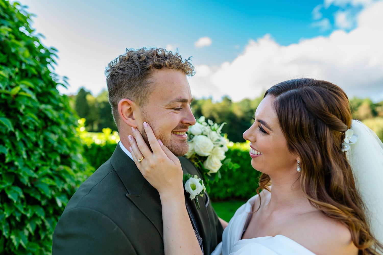 Romantic wedding couple shares intimate moments in a beautiful garden setting.