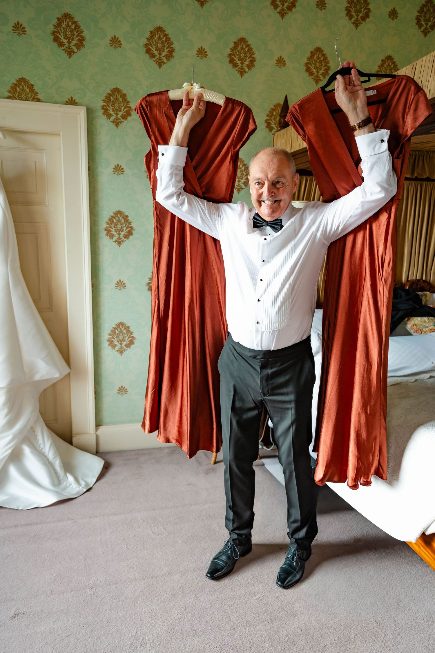 A sequence of photos showing someone getting dressed in formal attire with a red curtain in the background.