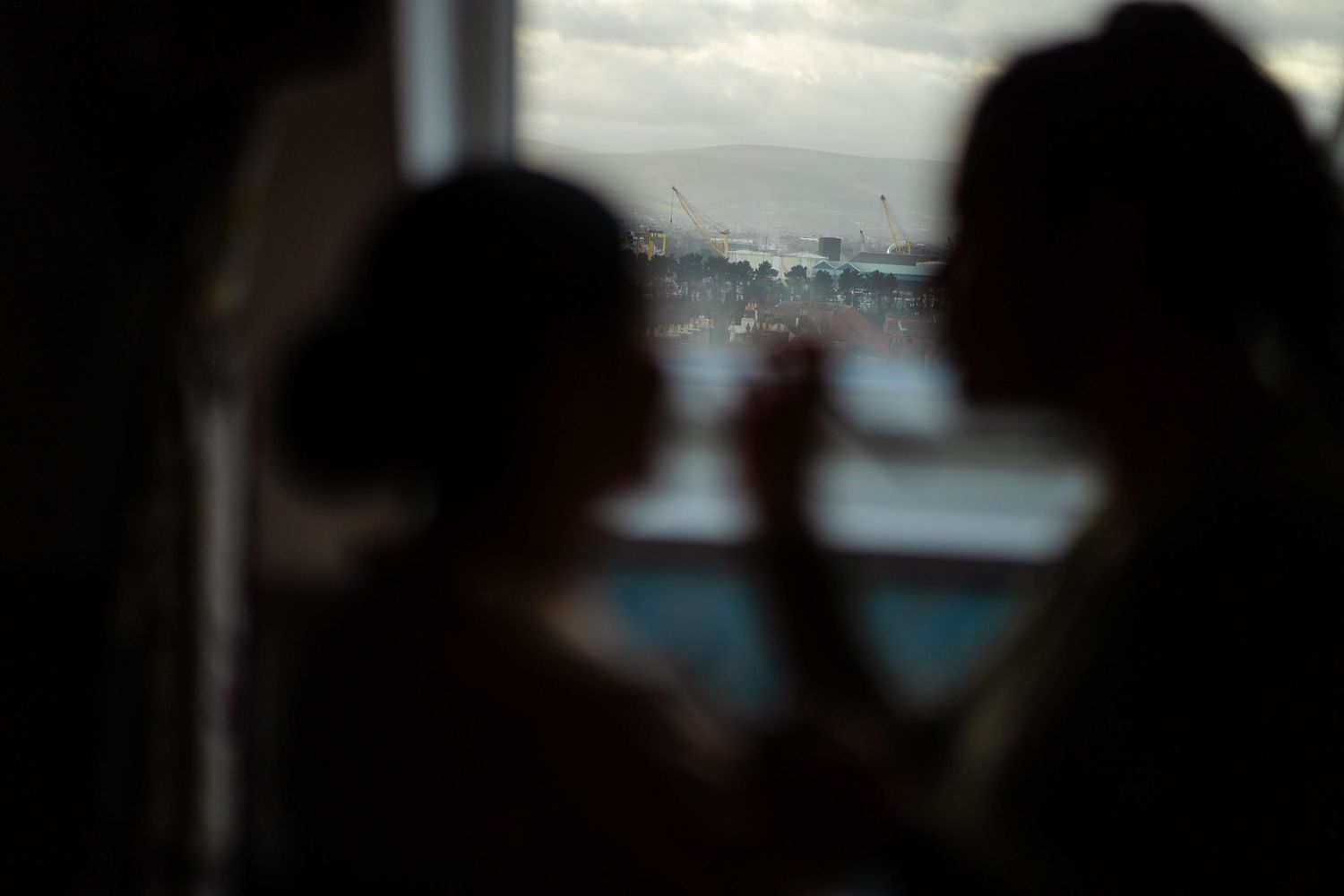 Silhouettes against window light creating dramatic shadows and contrast.