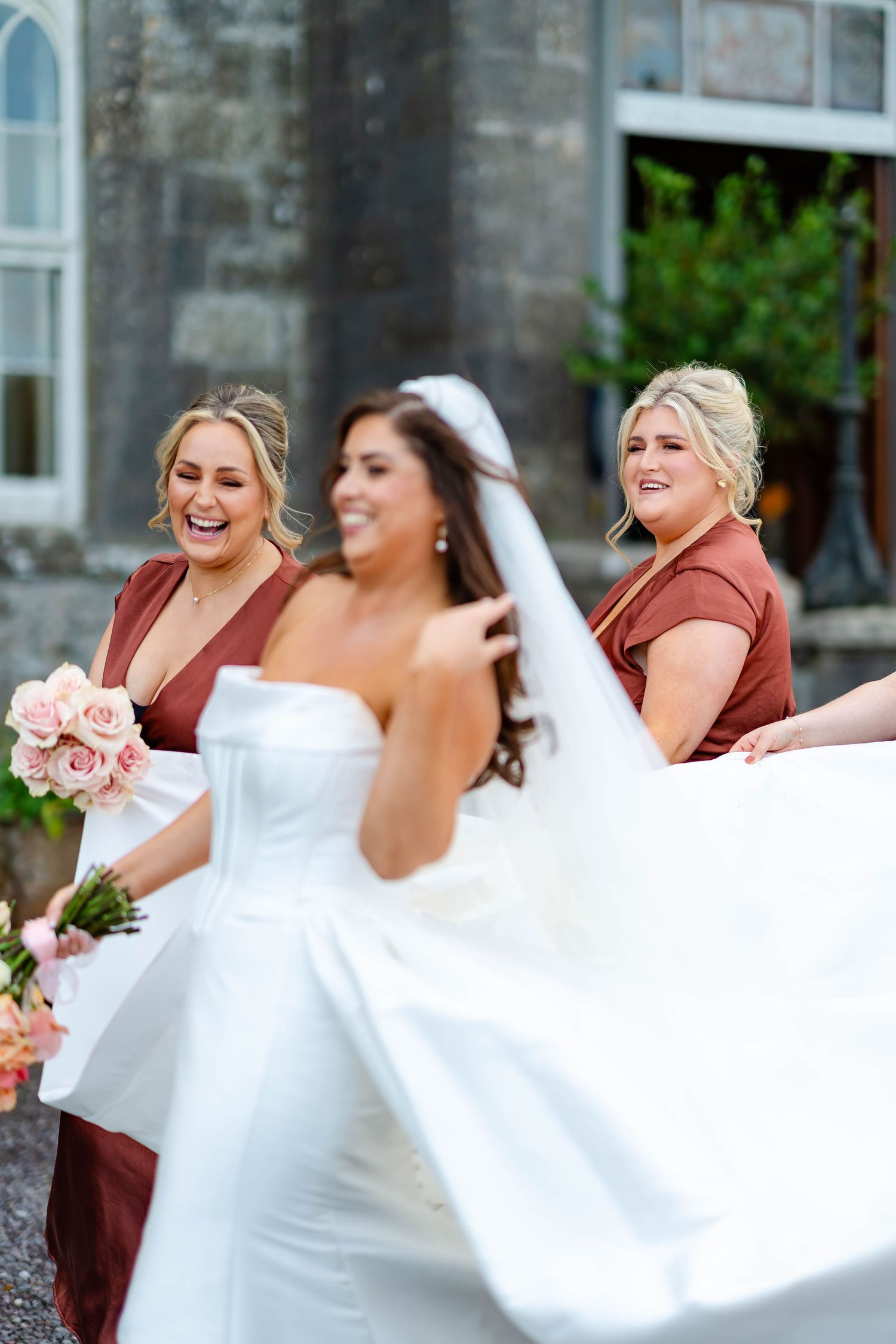 A joyful wedding party in burgundy and white dresses laughs together in a candid outdoor photo sequence.