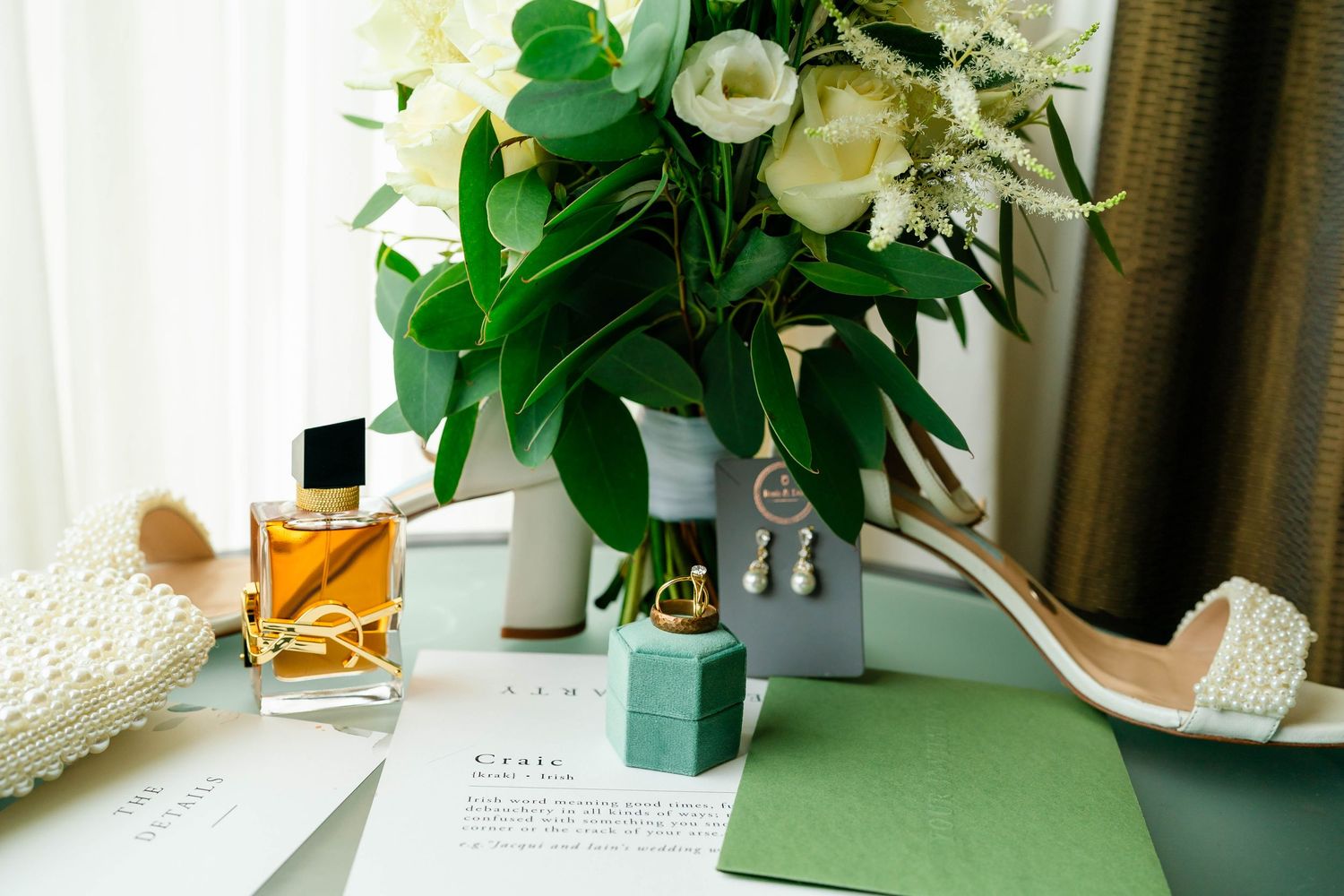 Elegant floral arrangements with white roses and greenery displayed in natural light.