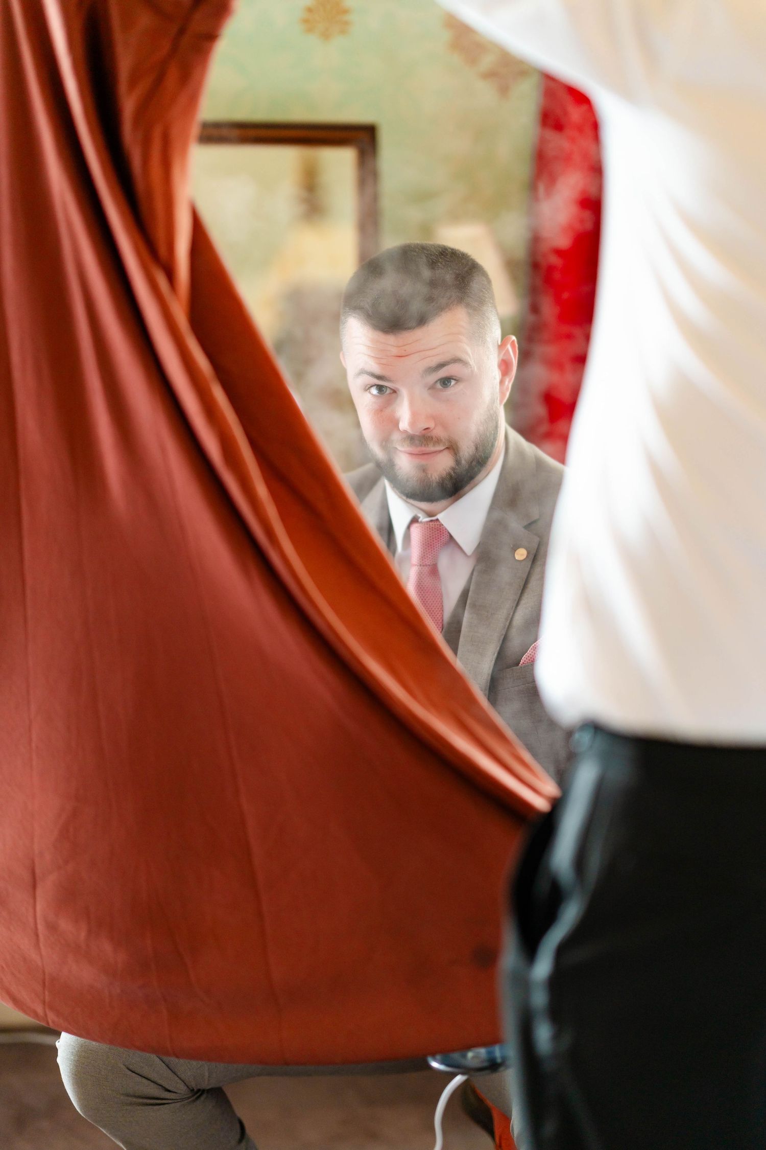 A sequence of photos showing someone peeking out from behind a red curtain in what appears to be a theater setting.