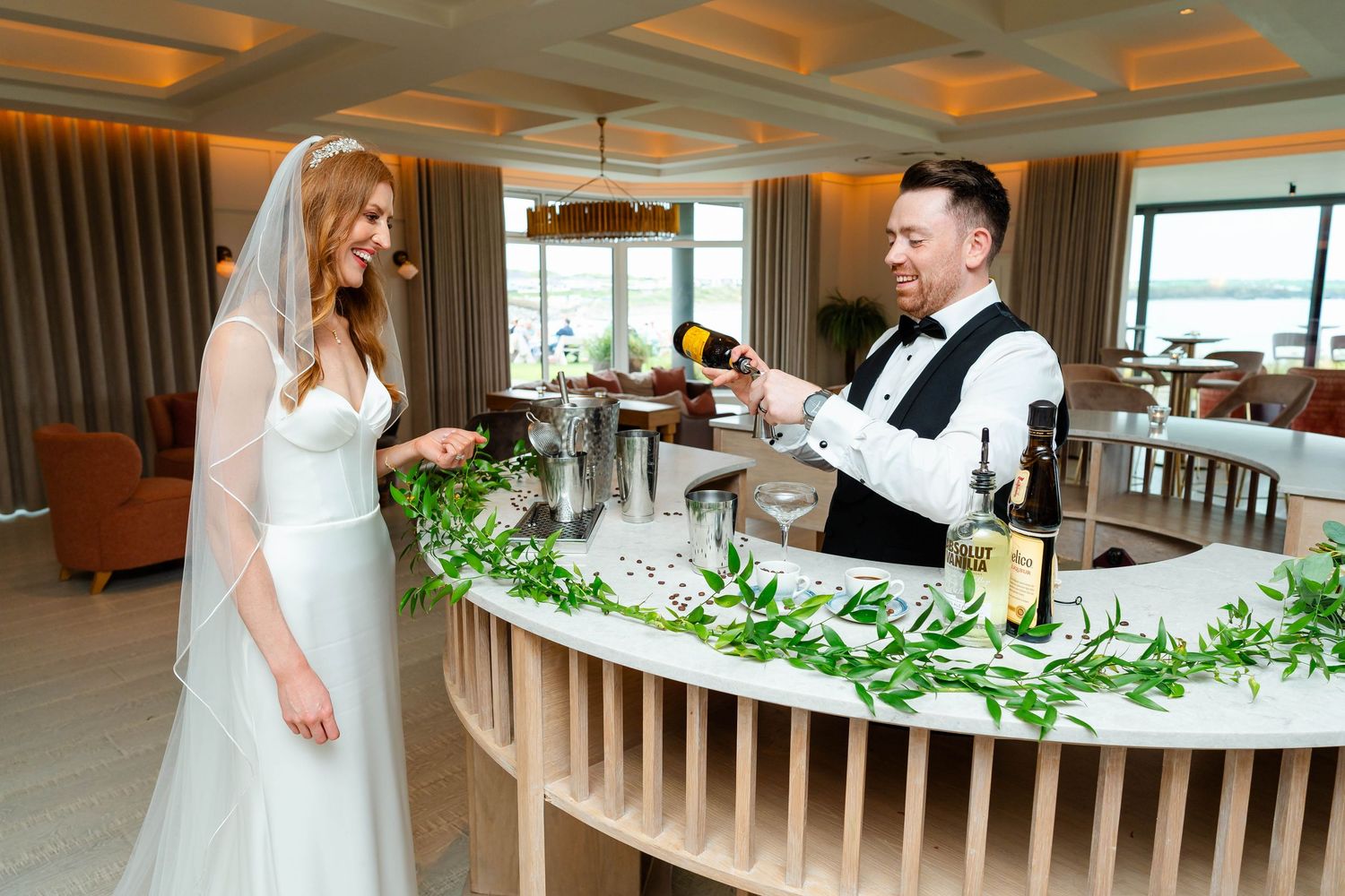 A modern wedding reception space with decorative ceiling details and ambient lighting.