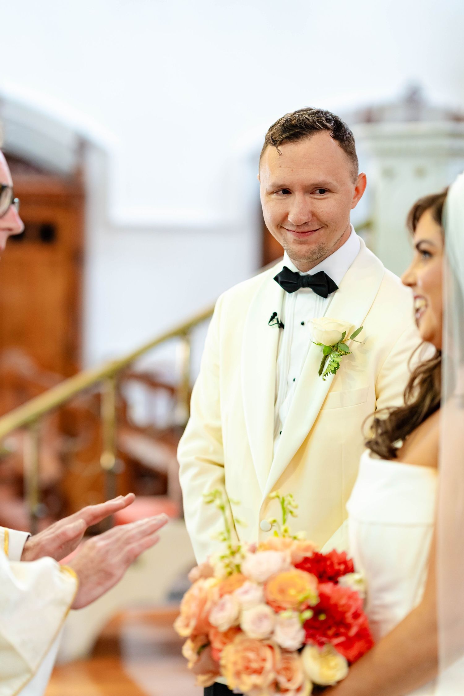 A series of wedding ceremony moments showing a groom in cream tuxedo with black bow tie and boutonniere.