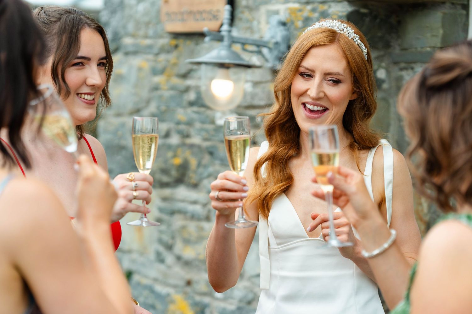 Friends enjoying drinks and conversation at an elegant outdoor gathering.