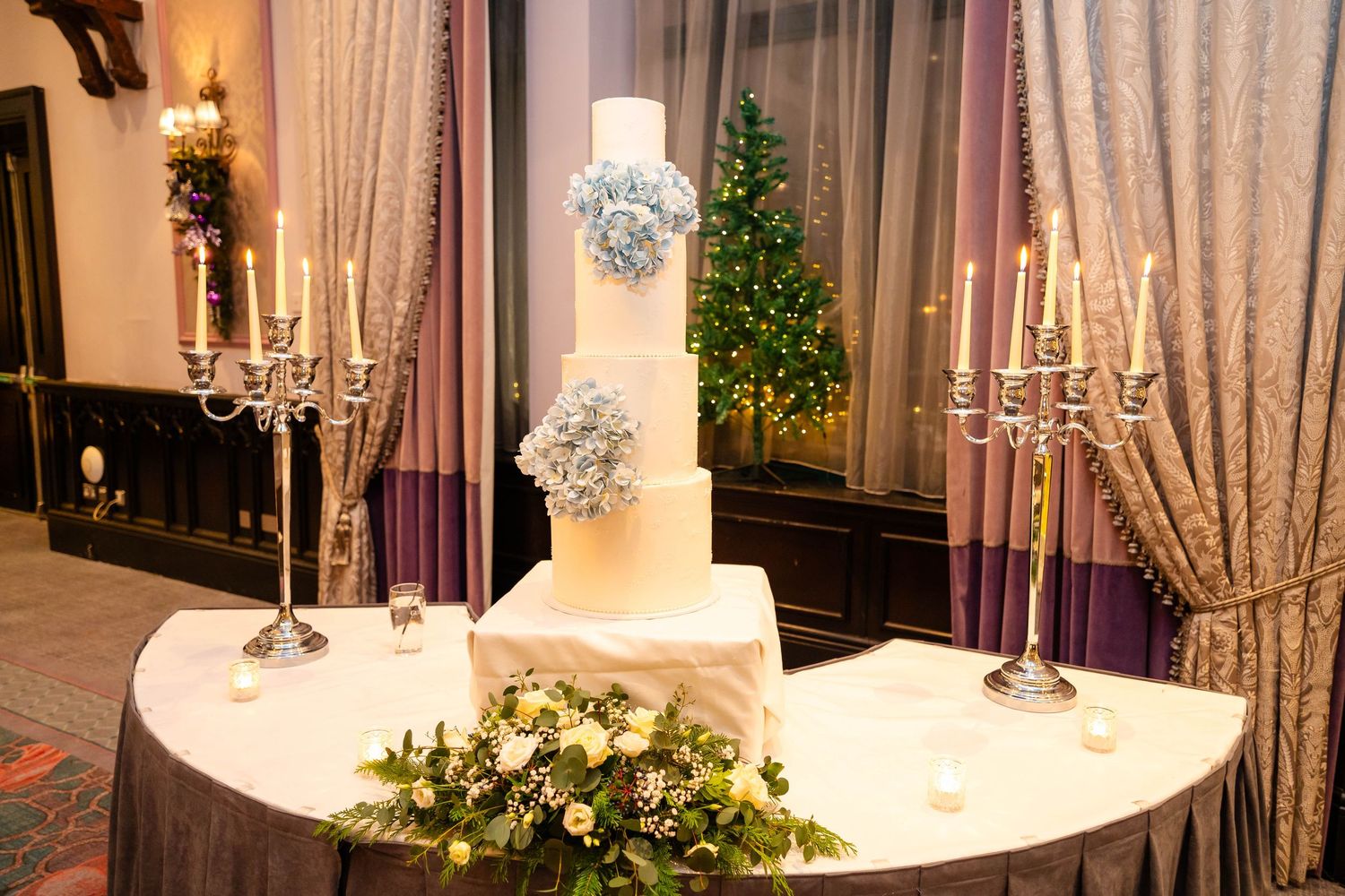 Elegant wedding reception setup with crystal chandeliers and floral arrangements.