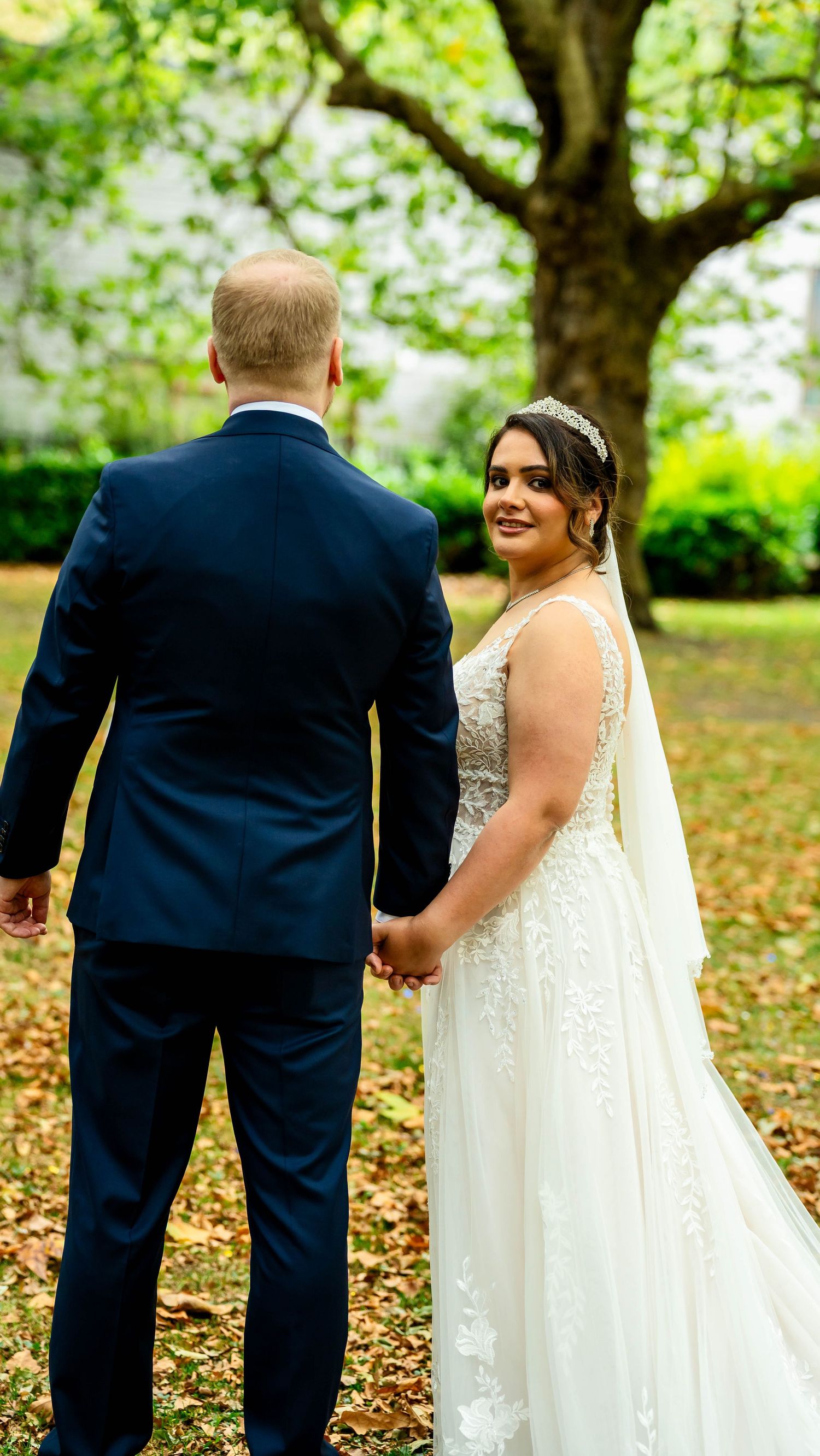 A romantic wedding photo sequence in a park with autumn leaves showing a couple walking together.