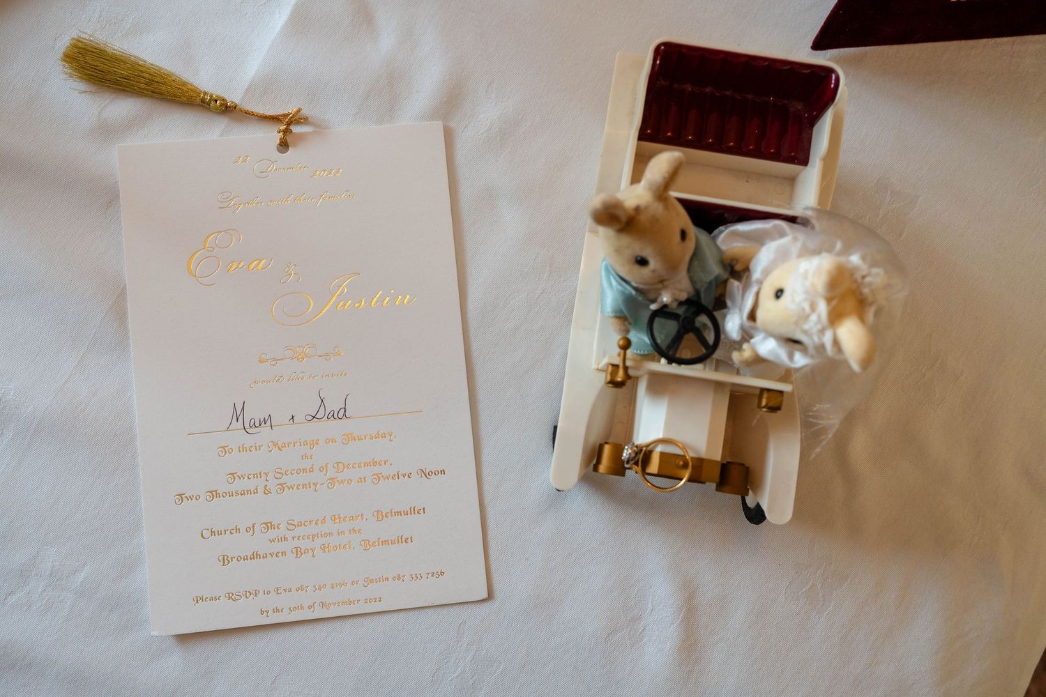 Elegant wedding invitations and paper details laid out on a light surface with delicate calligraphy.