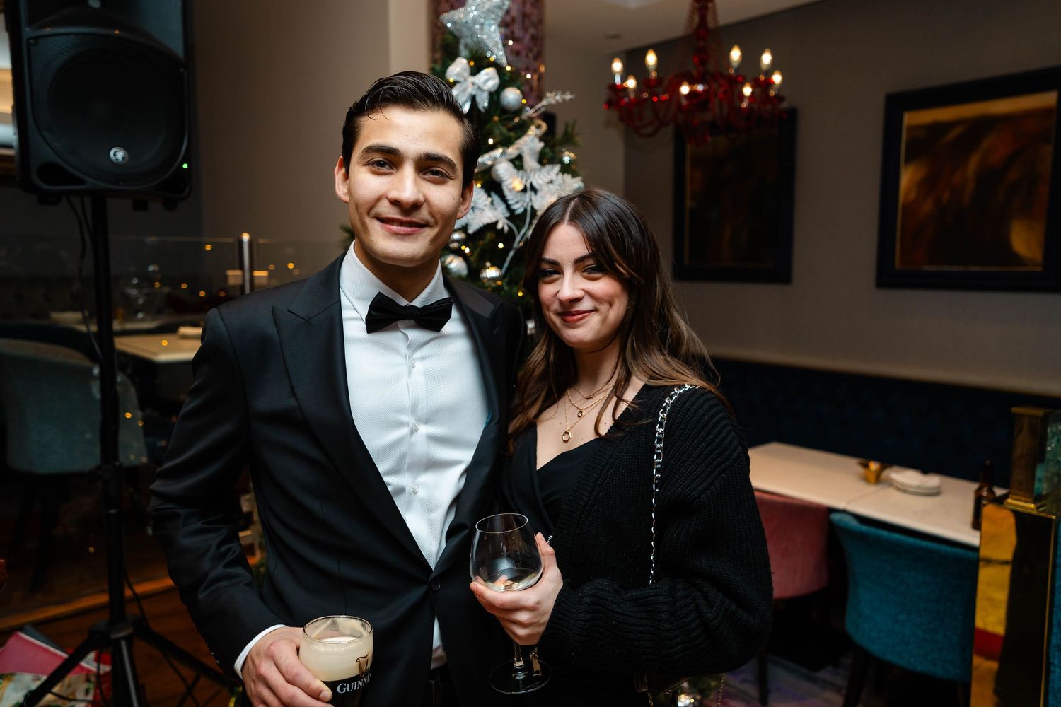 Couples enjoying an elegant evening celebration in formal black tie attire.