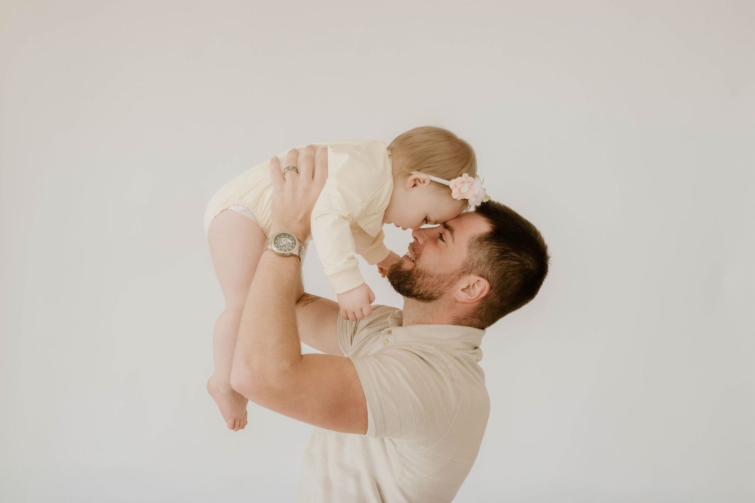 A parent in beige shirt holds and feeds a baby with a bottle in a series of tender moments.