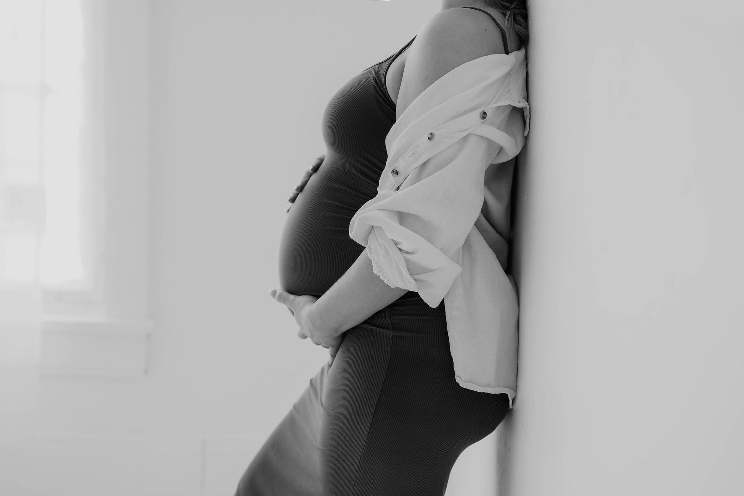 A black and white photo series showing intimate moments of a couple embracing and dancing together.