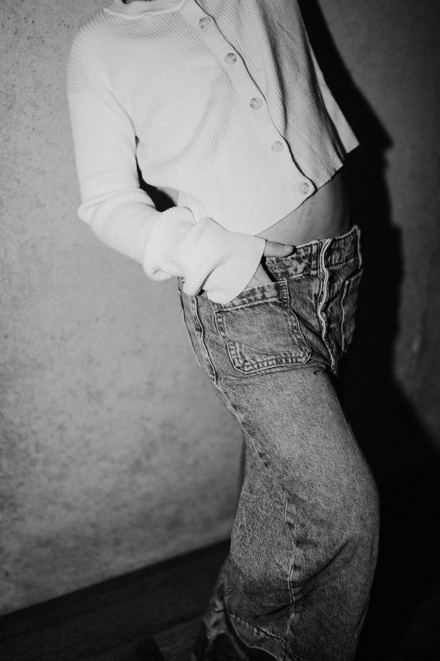 Black and white photo series showing close-up of someone wearing a white shirt and classic blue jeans.