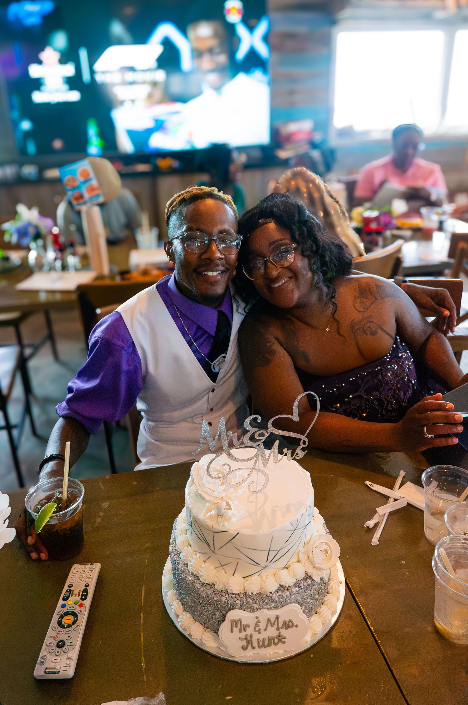 Bride and groom by their wedding cake