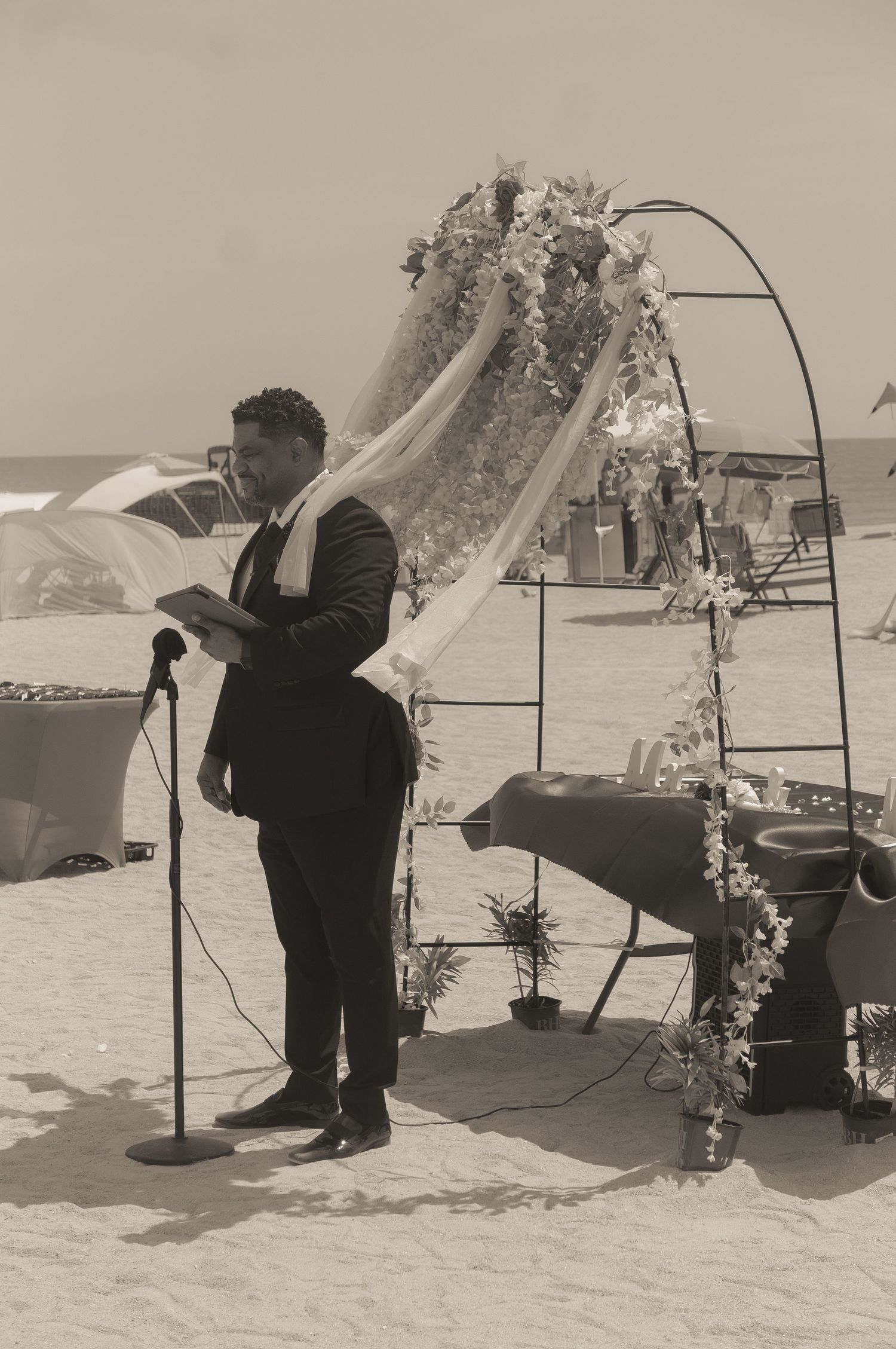 Minister standing before ceremony in black and white