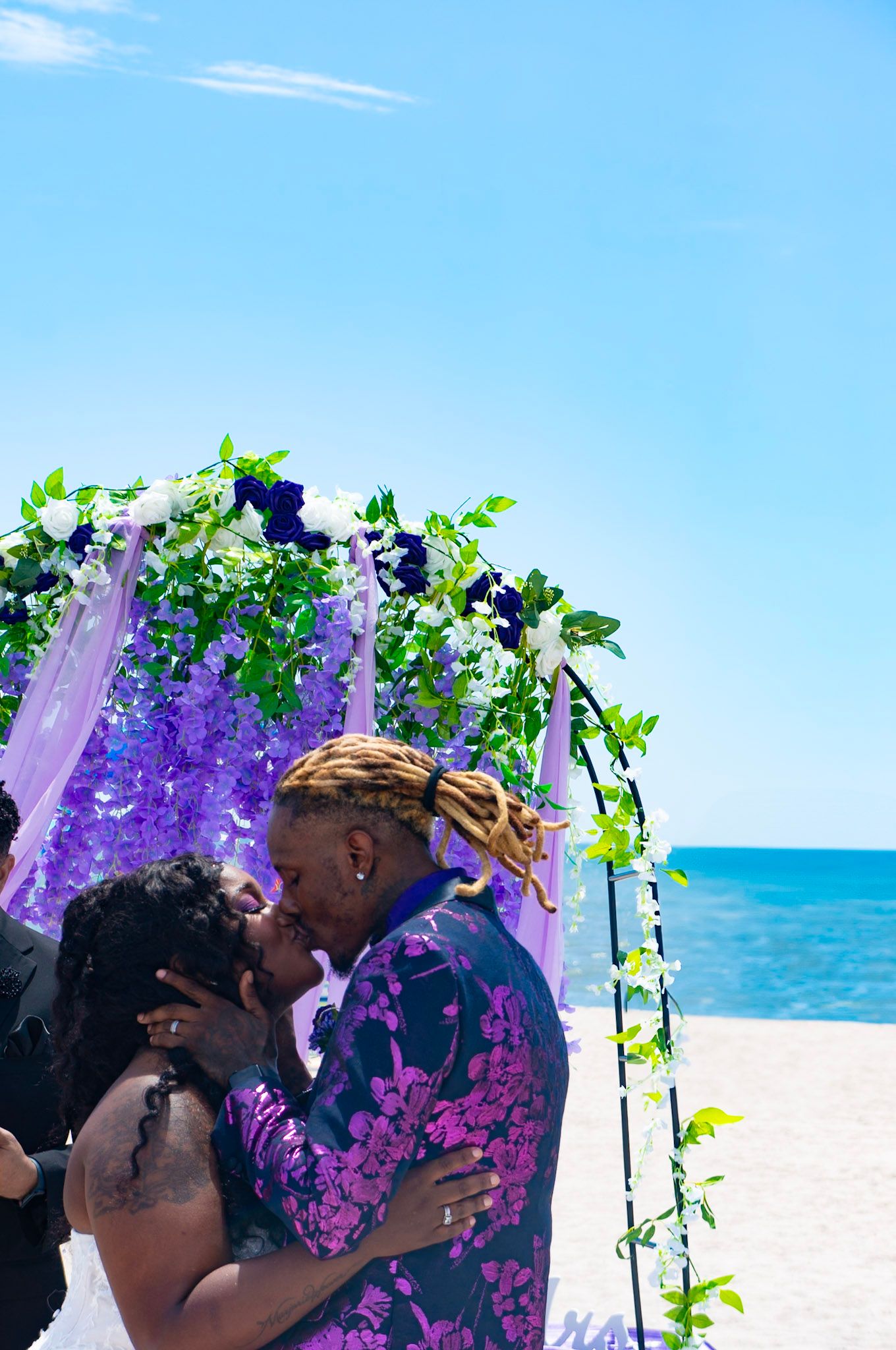 Bride and groom kissing at the altar