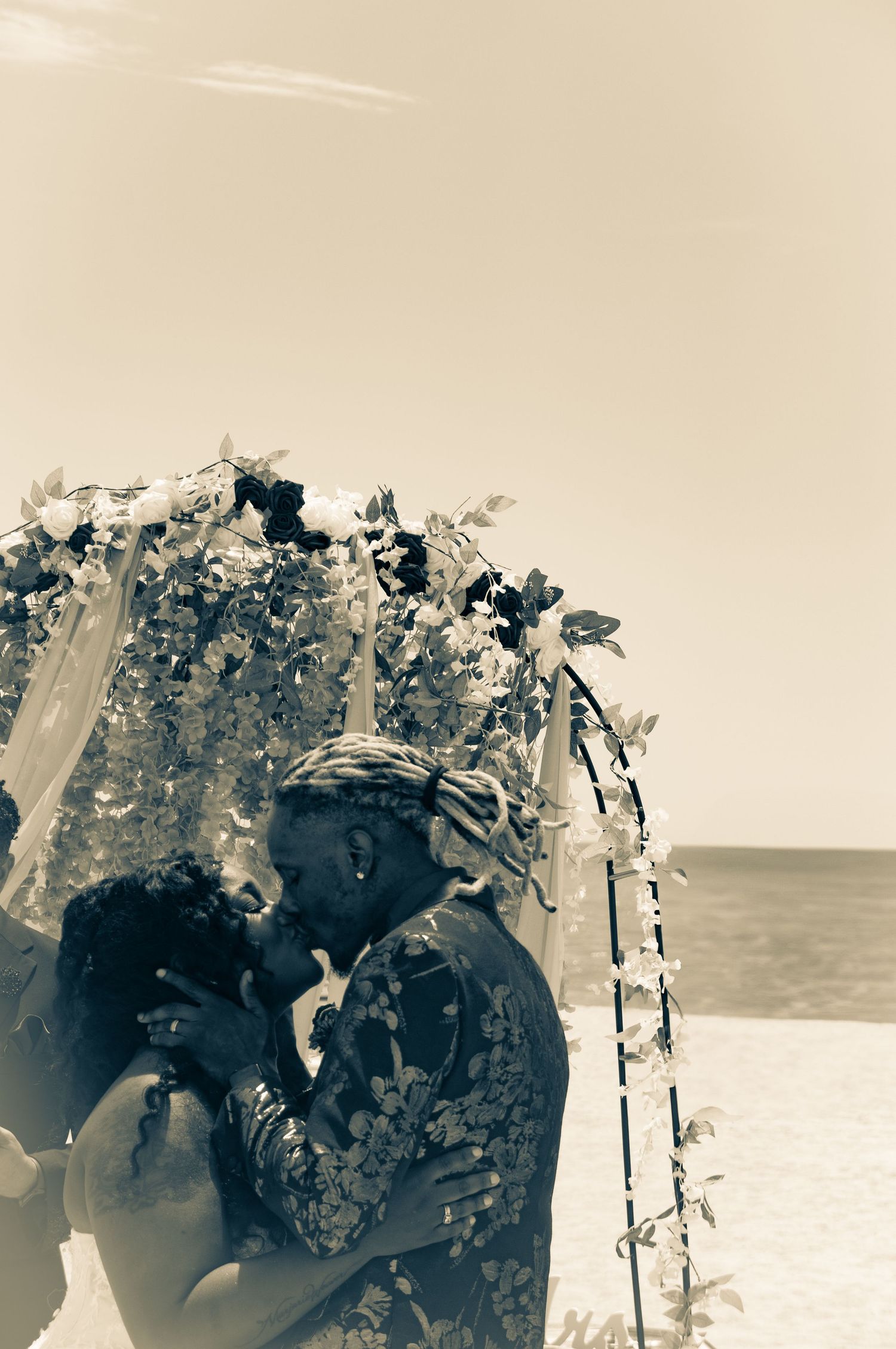 ride and groom sharing a romantic kiss in black and white