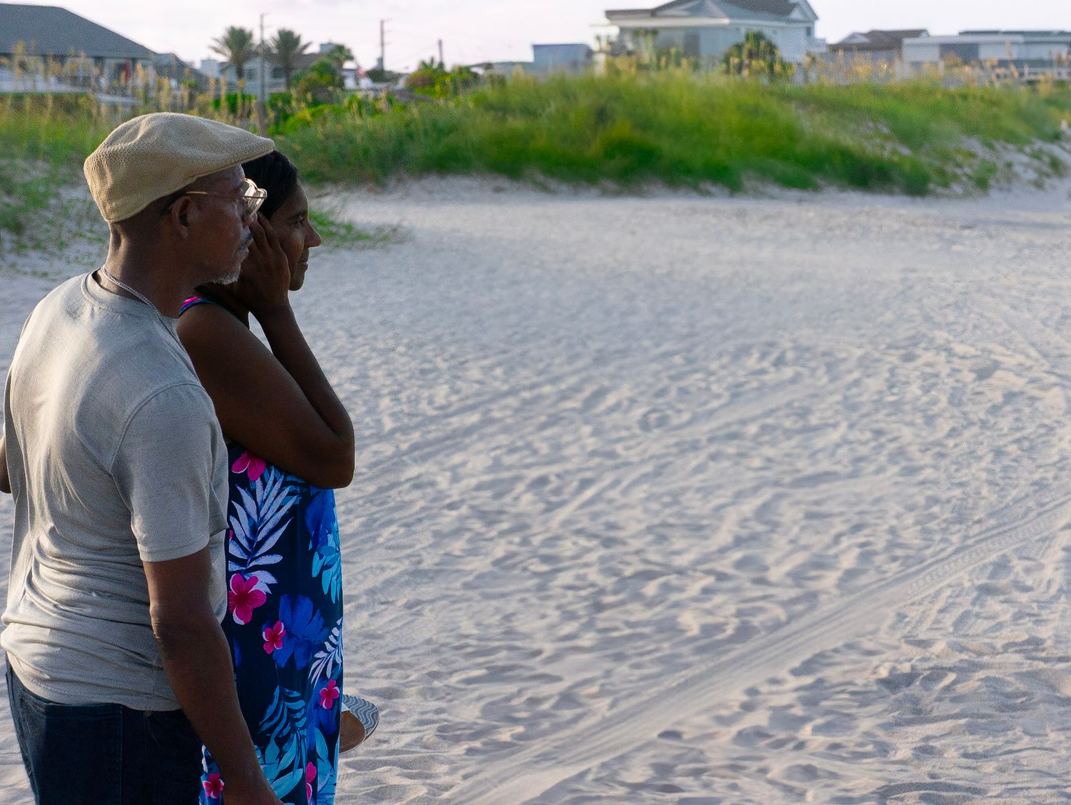 Man and women standing by each other on beach
