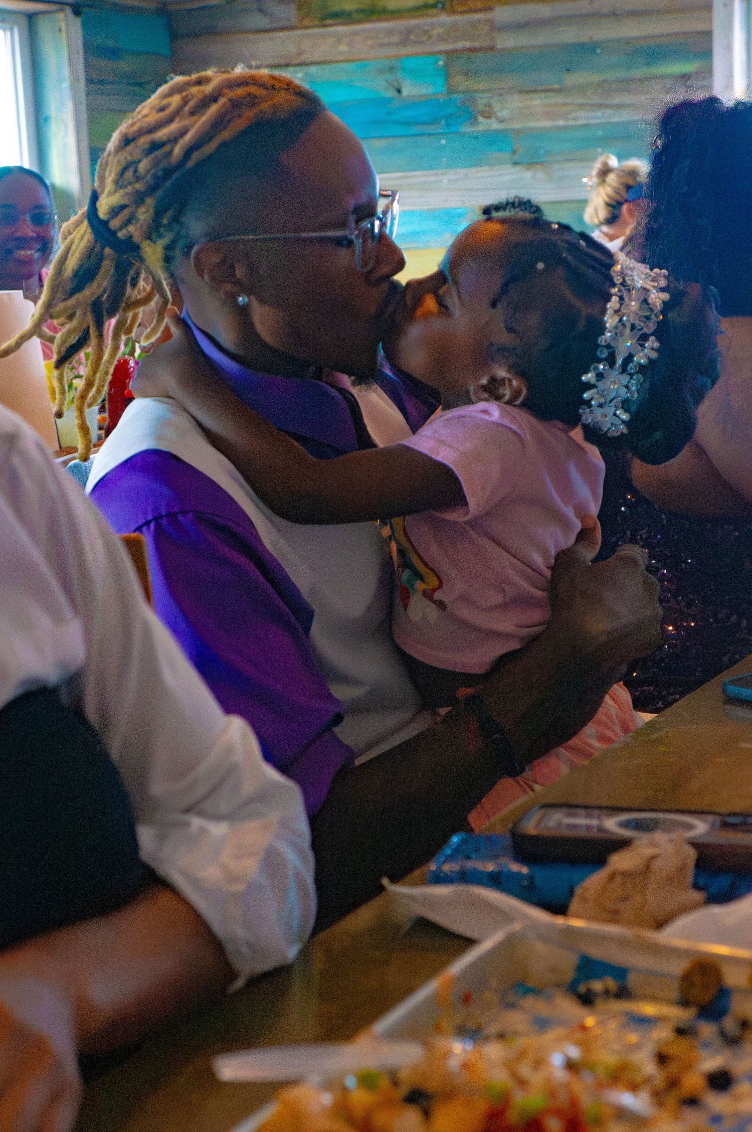 Father and daughter kissing at the reception