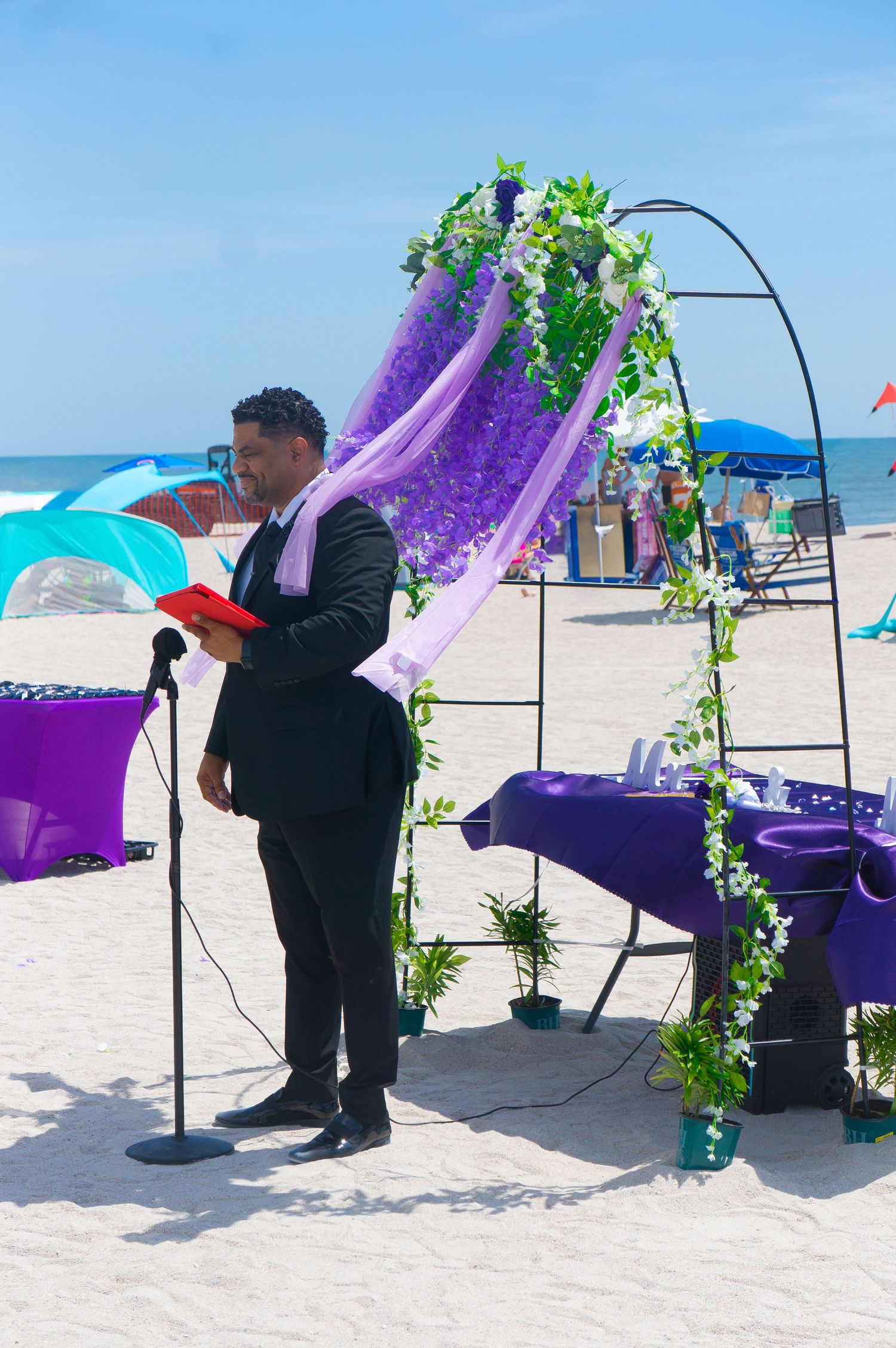 Minister standing before ceremony in front of purple altar