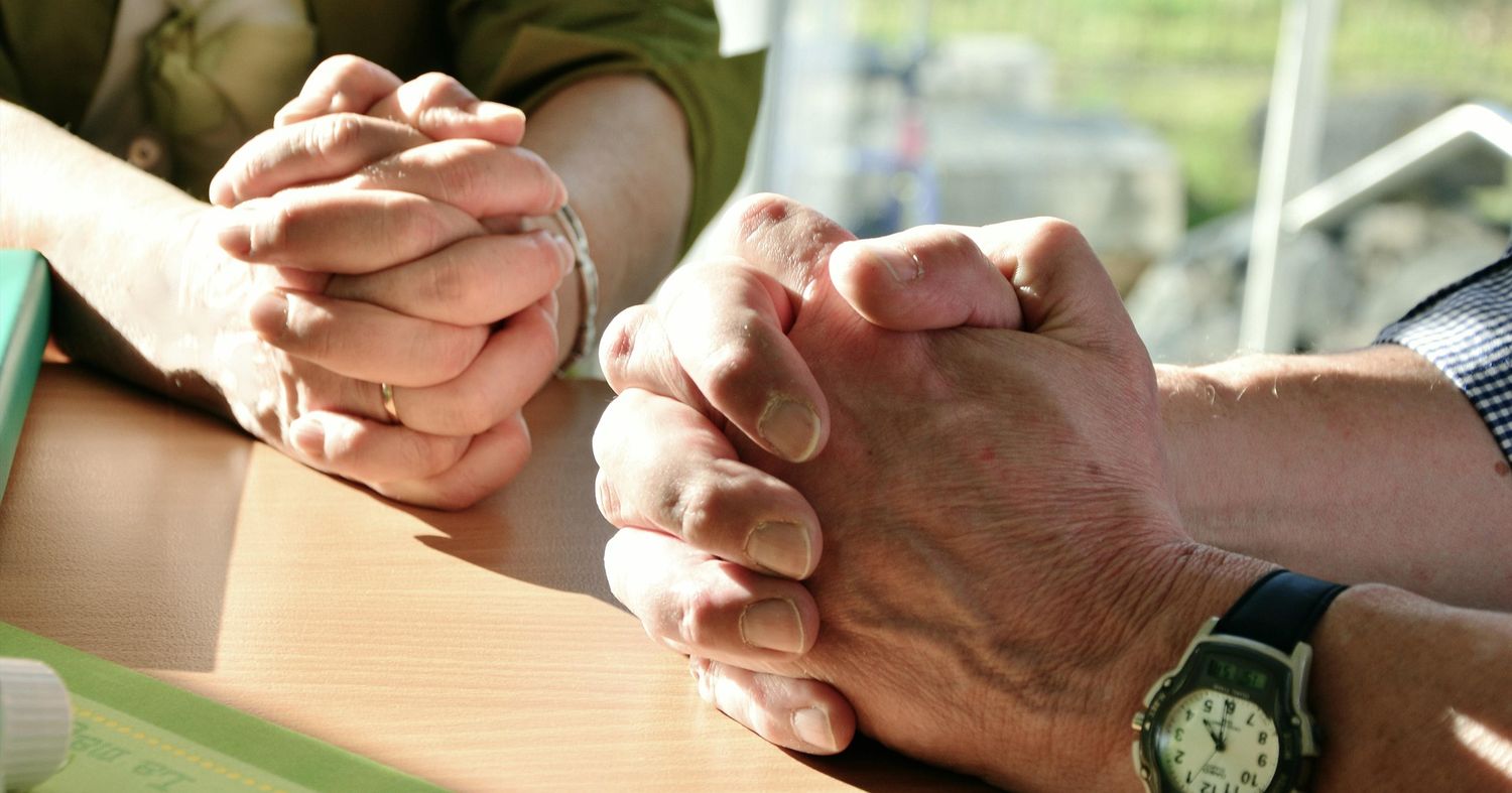 Close‑up of hands holding in a symbolic moment