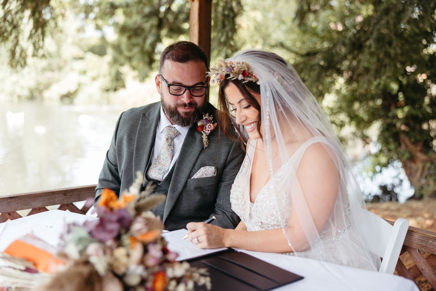 Newlyweds share a tender moment during their outdoor garden wedding reception.