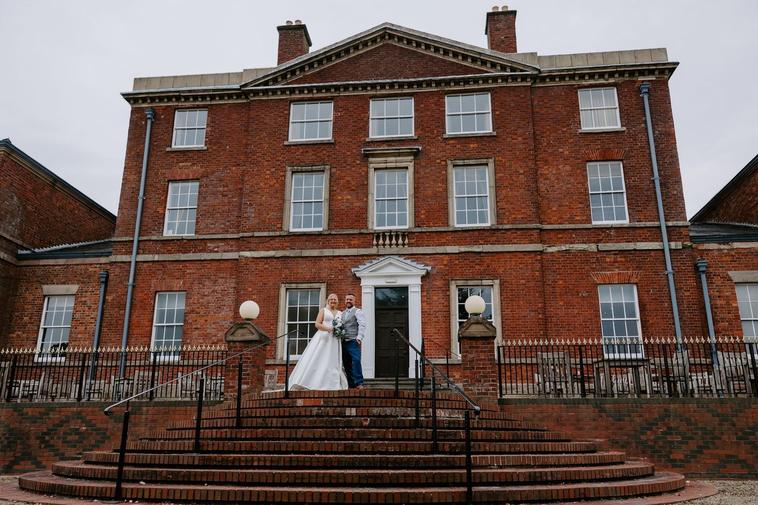 Historic red brick Georgian mansion with white trim windows and multiple chimneys viewed from different angles.