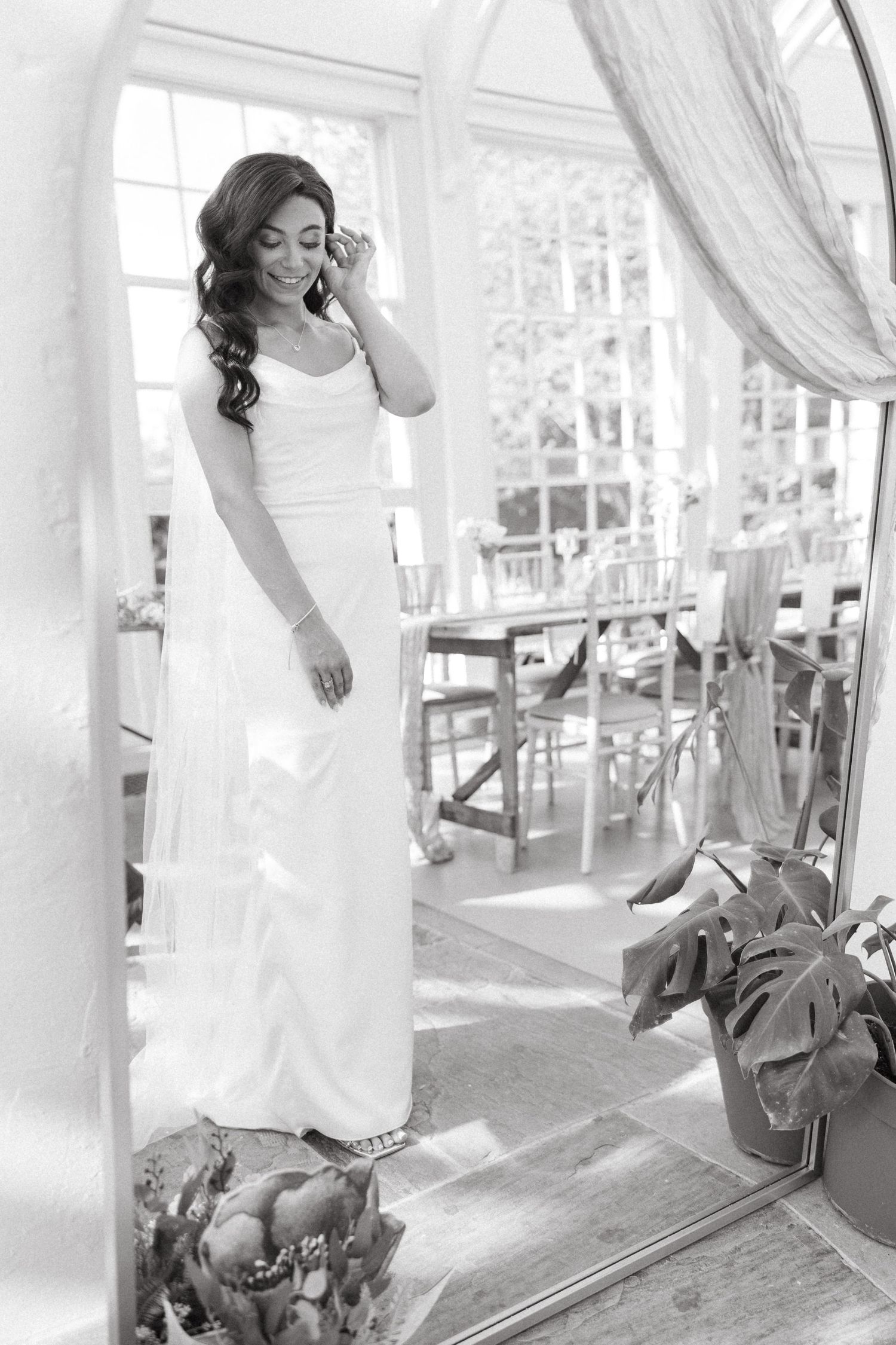 A collage of black and white wedding photos showing a bride in a white dress posing in various romantic settings.